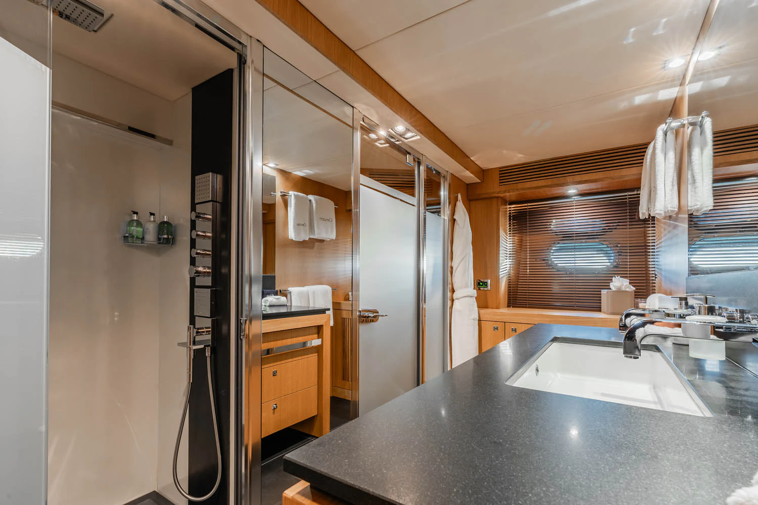 a bathroom with a countertop sink and a shower unit aboard LUNA ROSSA Yacht for Charter
