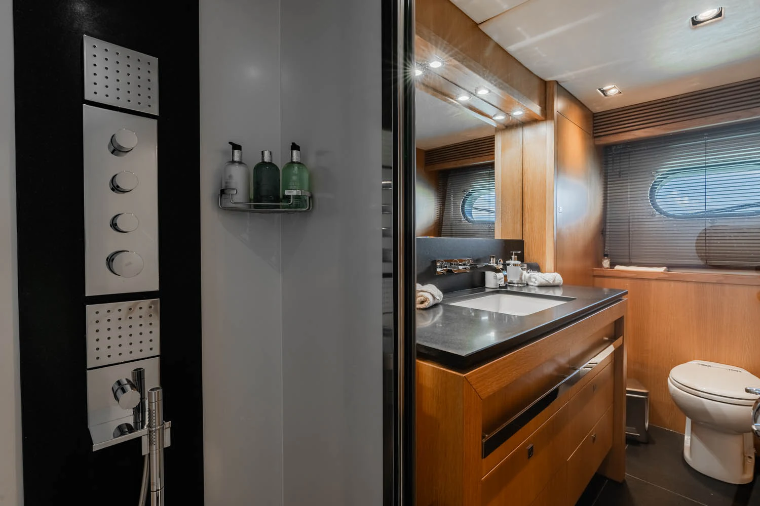 a bathroom with a sink toilet and a mirror aboard LUNA ROSSA Yacht for Charter