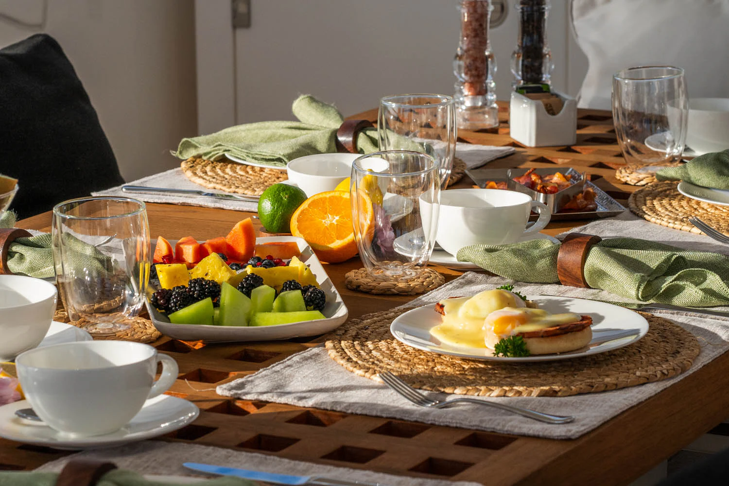 a table with food and glasses aboard LUNA ROSSA Yacht for Charter