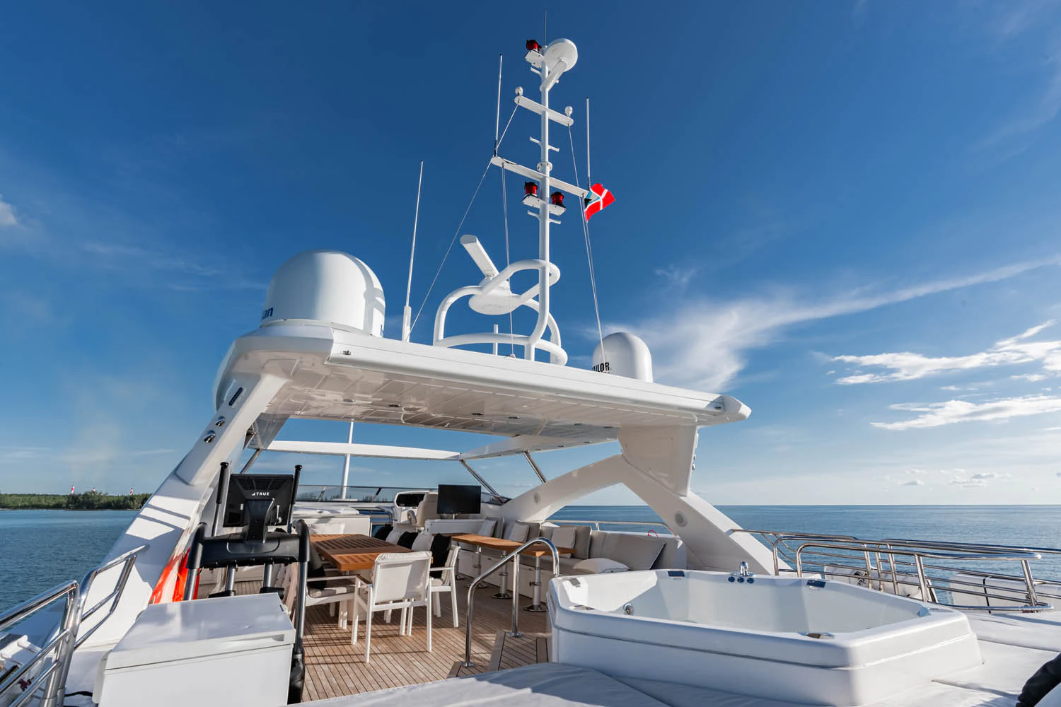 a white boat on a dock aboard LUNA ROSSA Yacht for Charter