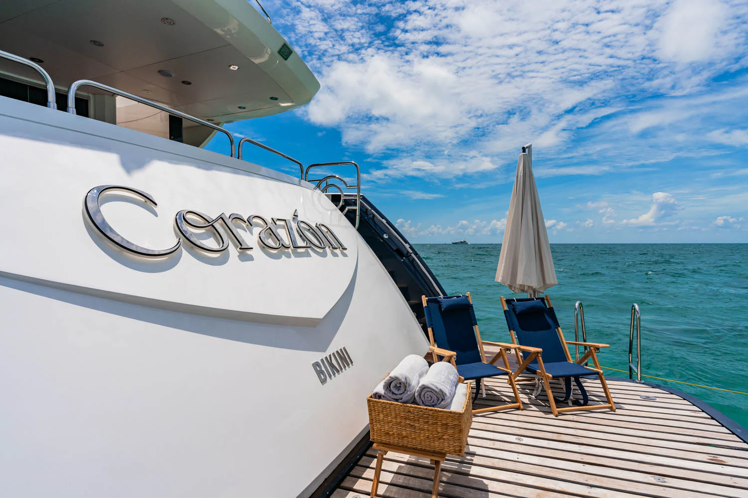 a boat with chairs and tables on a deck by the water aboard LUNA ROSSA Yacht for Charter