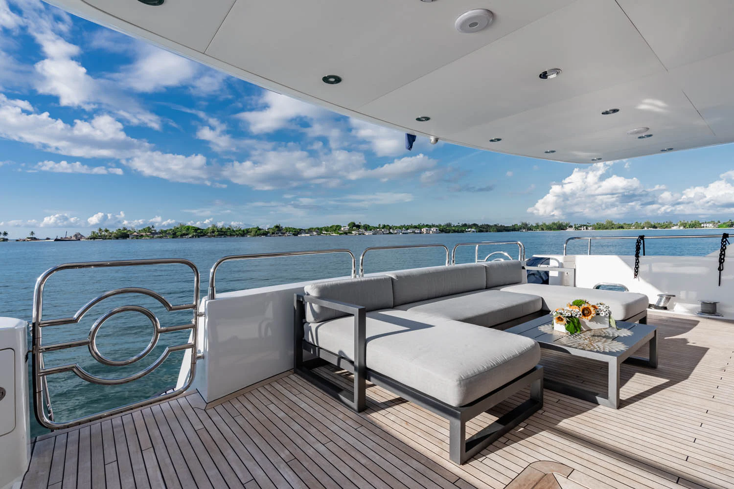 a large white lounge chair on a deck overlooking a body of water aboard LUNA ROSSA Yacht for Charter