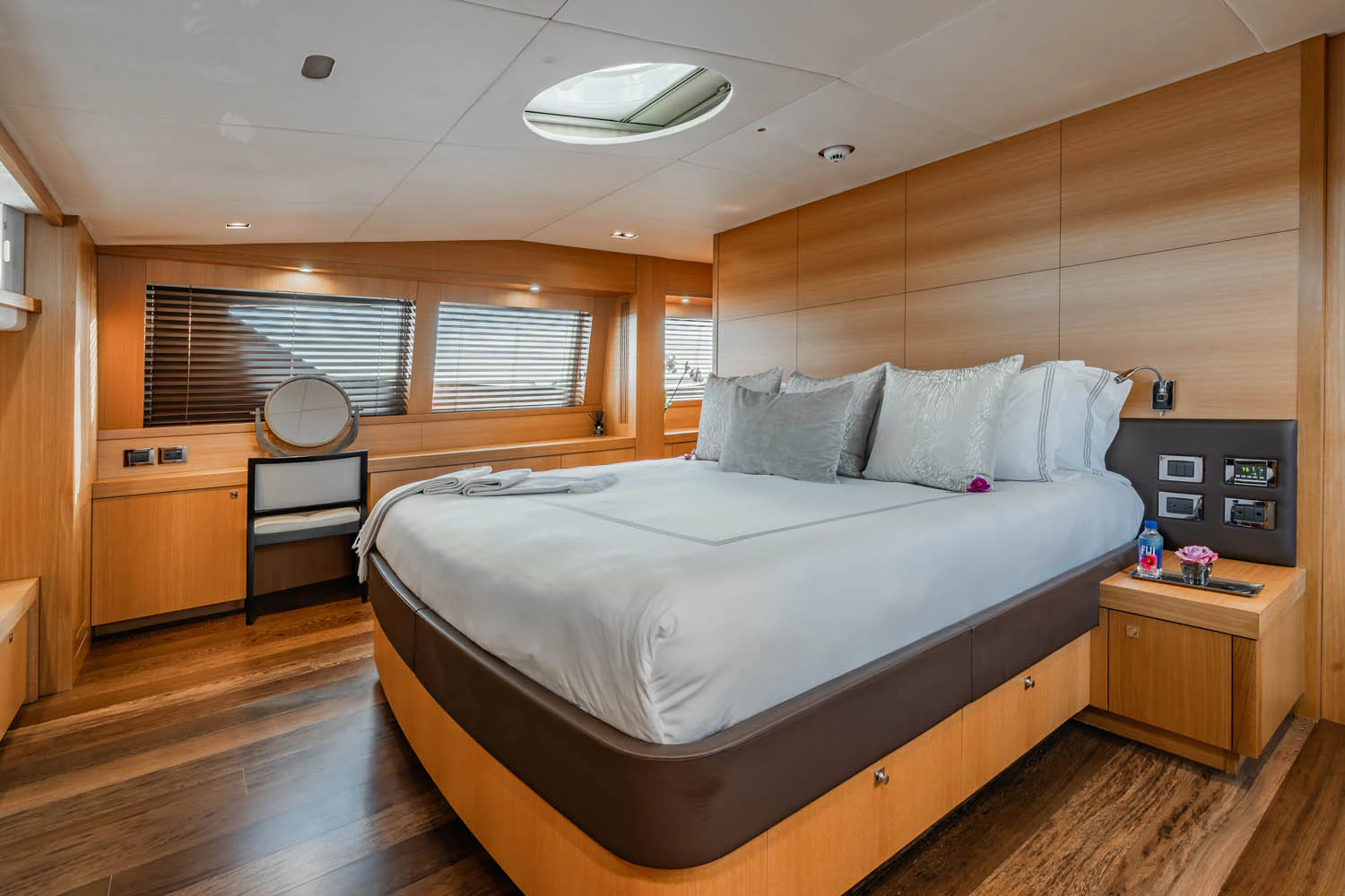 a bedroom with a bed and a desk aboard LUNA ROSSA Yacht for Charter