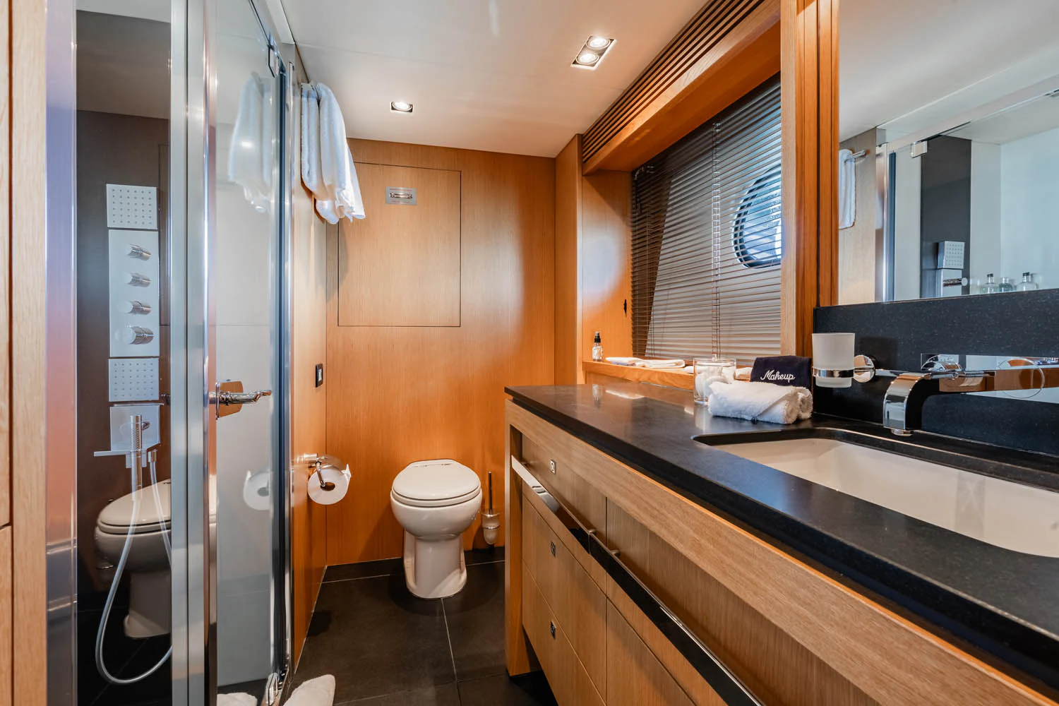 a bathroom with a shower unit and sink aboard LUNA ROSSA Yacht for Charter