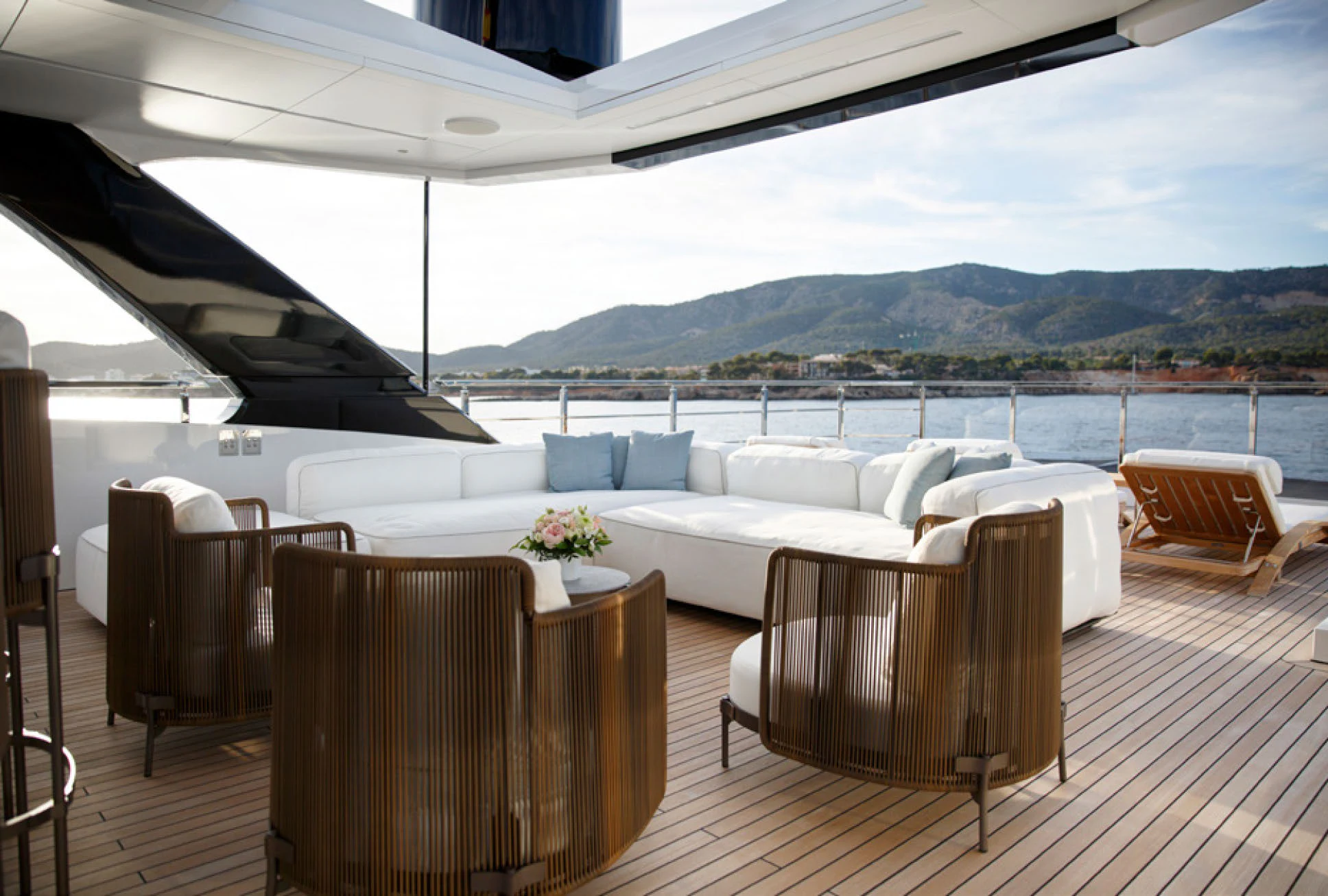 a large white lounge chair on a deck overlooking a large body of water aboard PERLA BIANCA Yacht for Charter