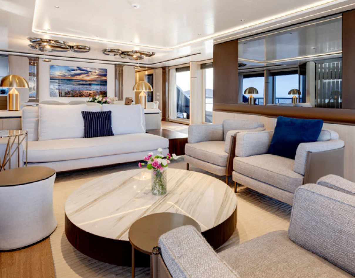 a living room with a table and couches aboard PERLA BIANCA Yacht for Charter