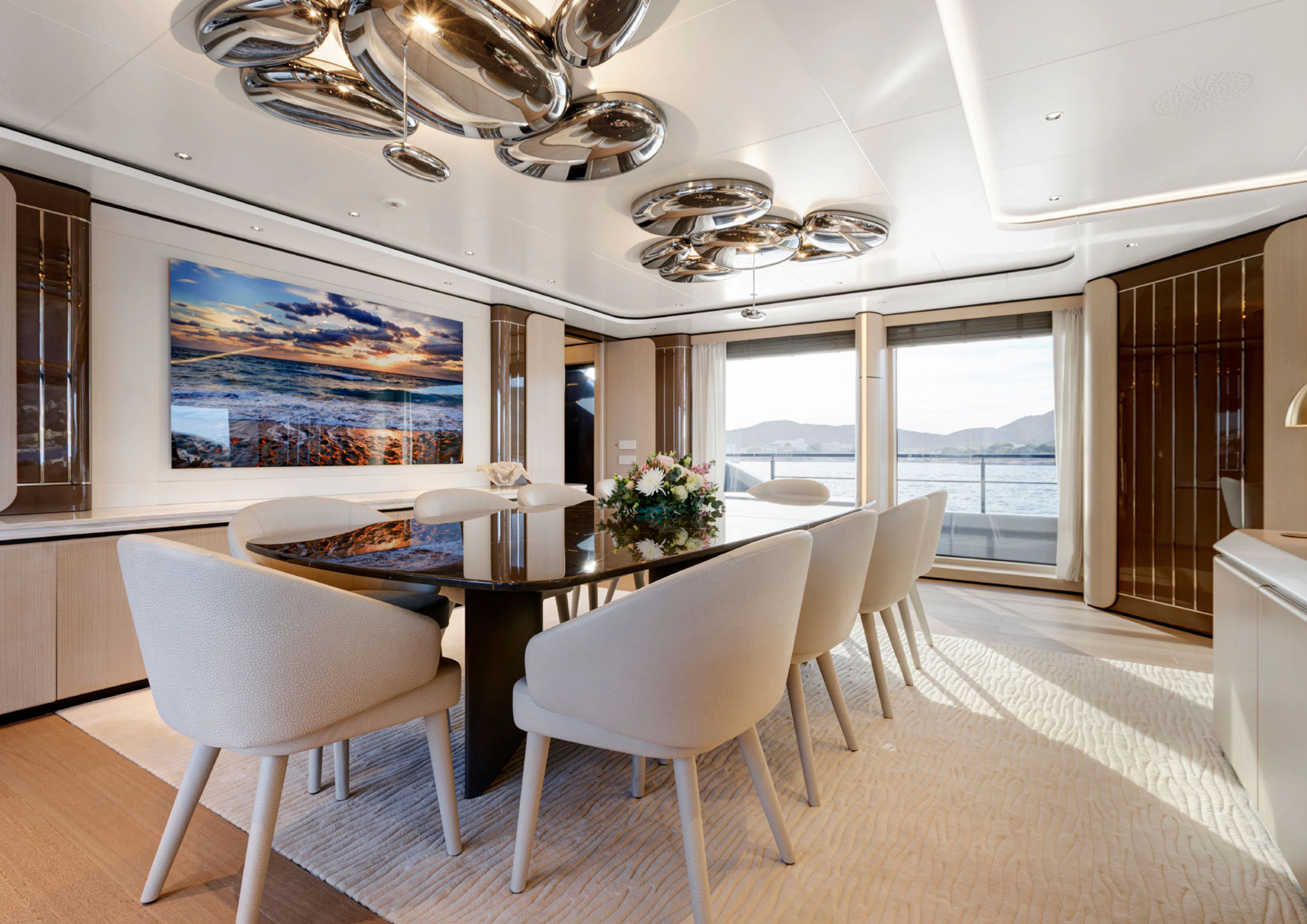 a large dining room with a large table and chairs aboard PERLA BIANCA Yacht for Charter