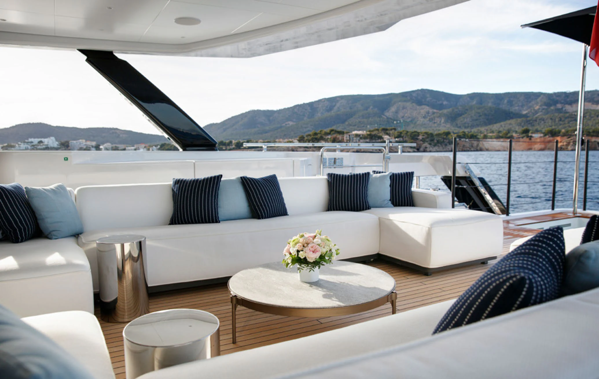 a white couch and table on a boat aboard PERLA BIANCA Yacht for Charter