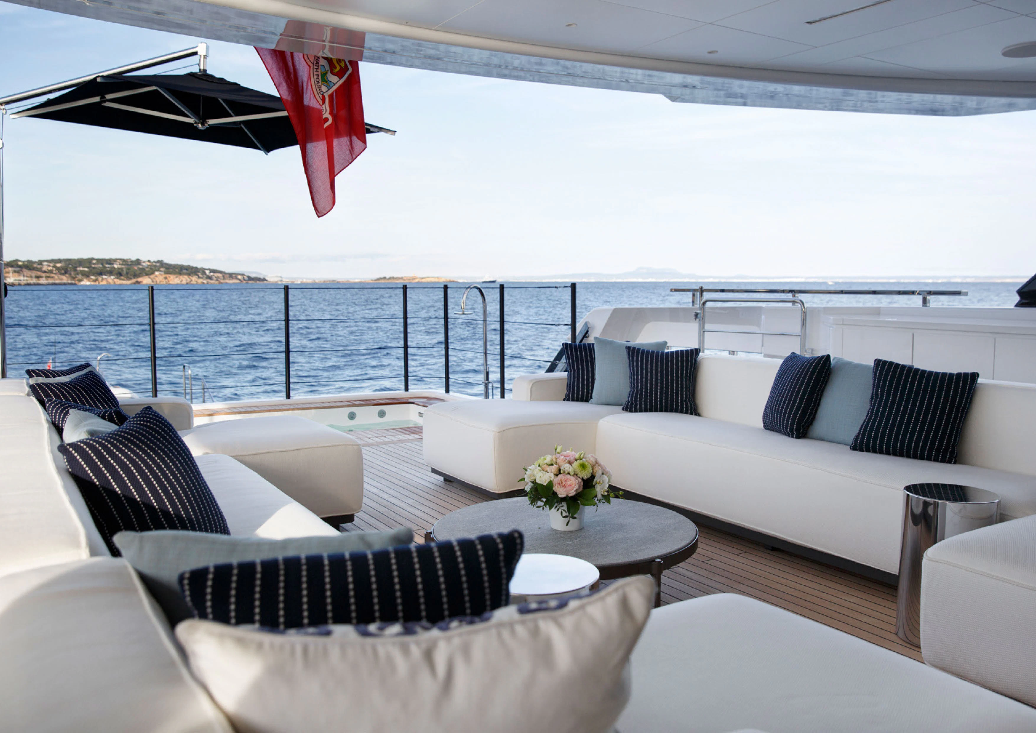 a white couch and a table on a boat aboard PERLA BIANCA Yacht for Charter
