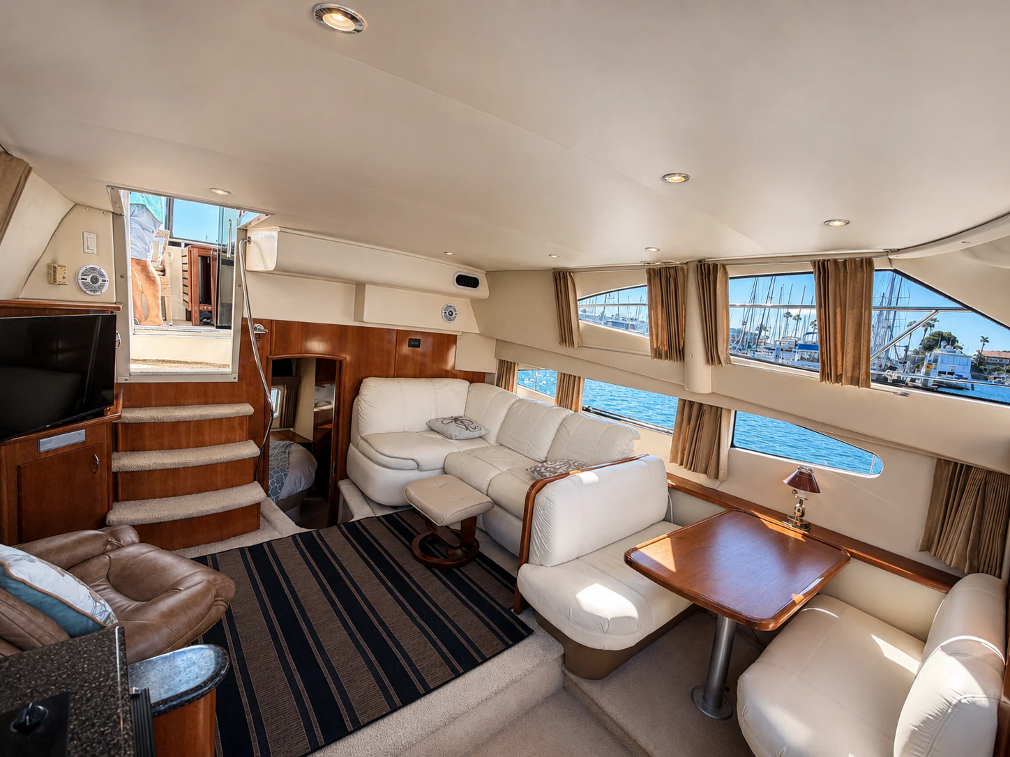 a living room with a large window aboard PARADIGM Yacht for Sale