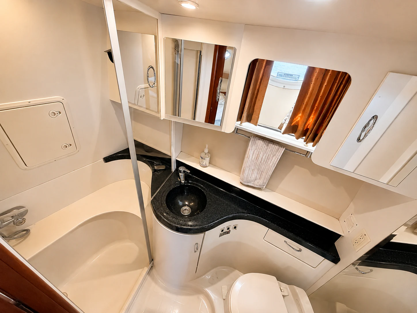 a bathroom with a tub sink and mirror aboard PARADIGM Yacht for Sale
