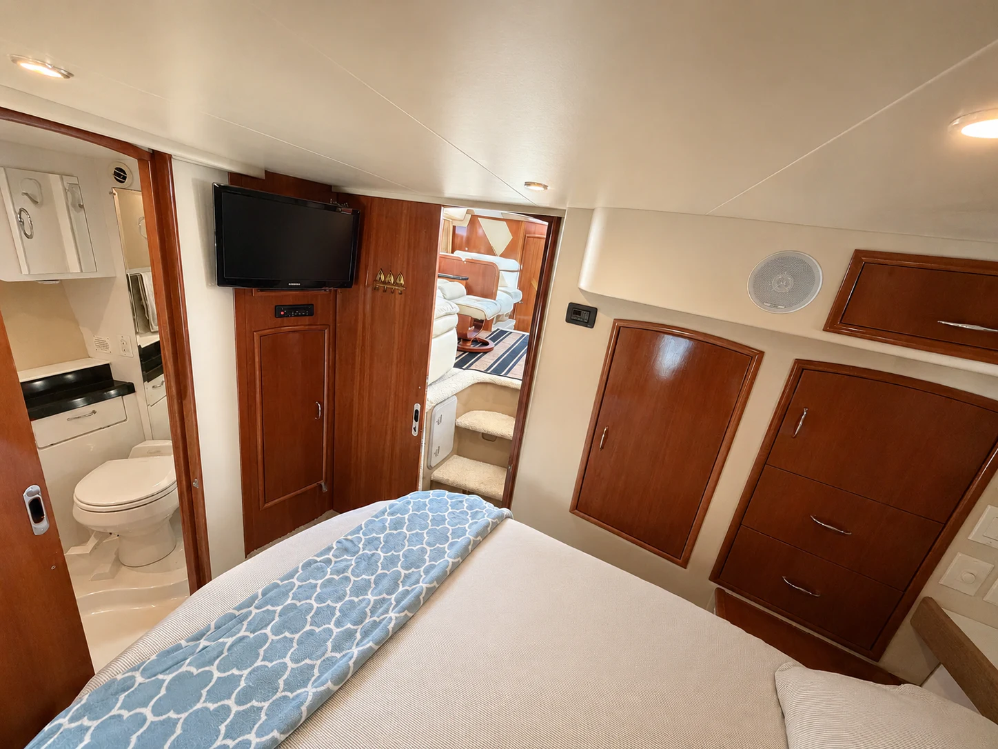 a bedroom with a bed and a television aboard PARADIGM Yacht for Sale