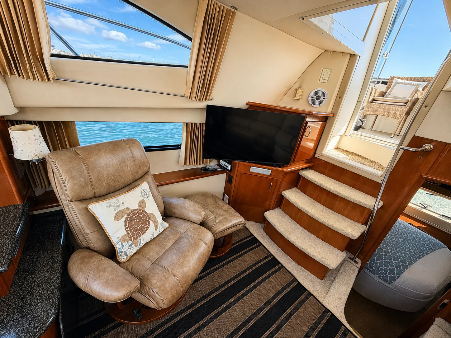 a living room with a tv and a couch aboard PARADIGM Yacht for Sale