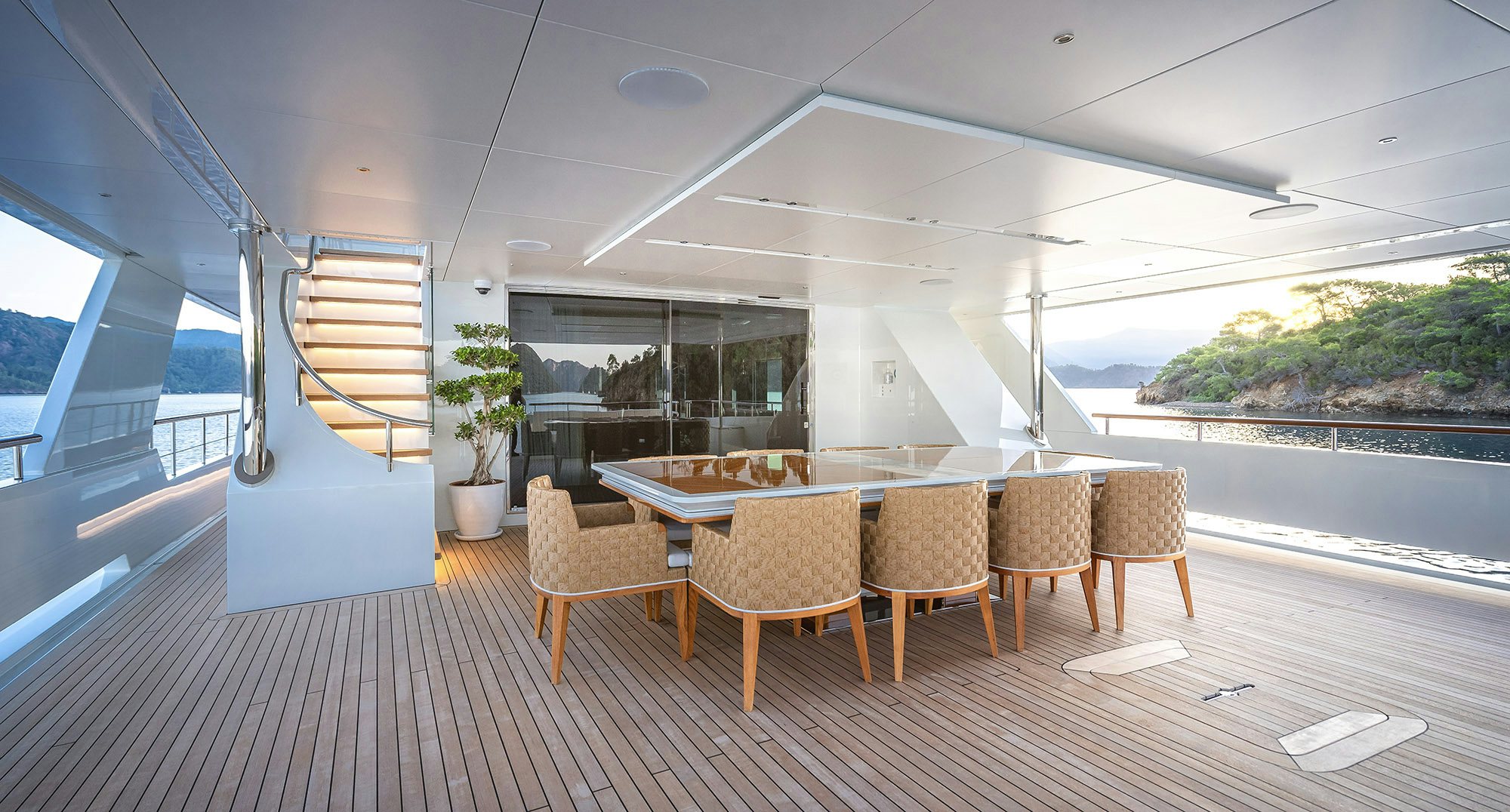 a room with a table chairs and a staircase aboard SUNRISE Yacht for Sale