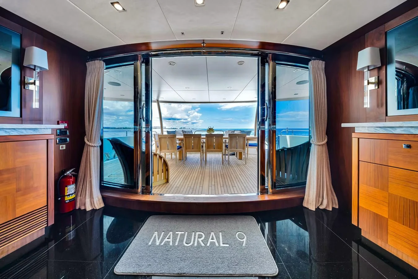 a room with a glass door and a large window aboard NATURAL 9 Yacht for Charter