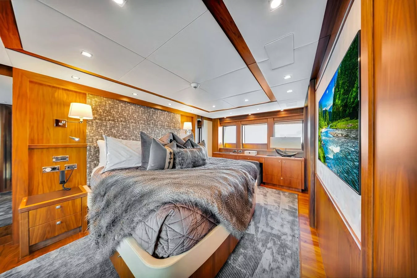 a bedroom with a bed and a wood cabinet aboard NATURAL 9 Yacht for Charter