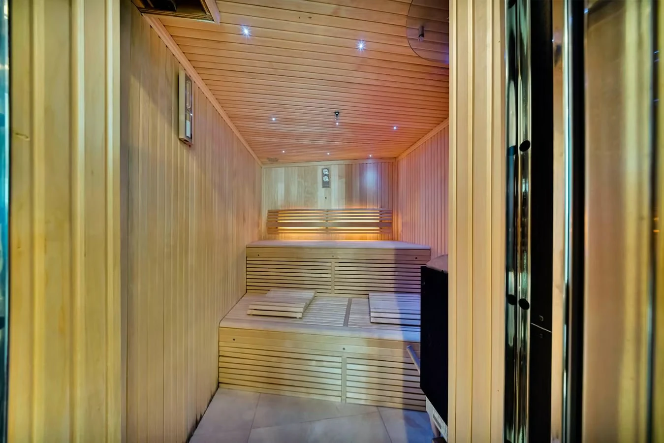 a room with a wood staircase and a large window with a railing aboard NATURAL 9 Yacht for Charter