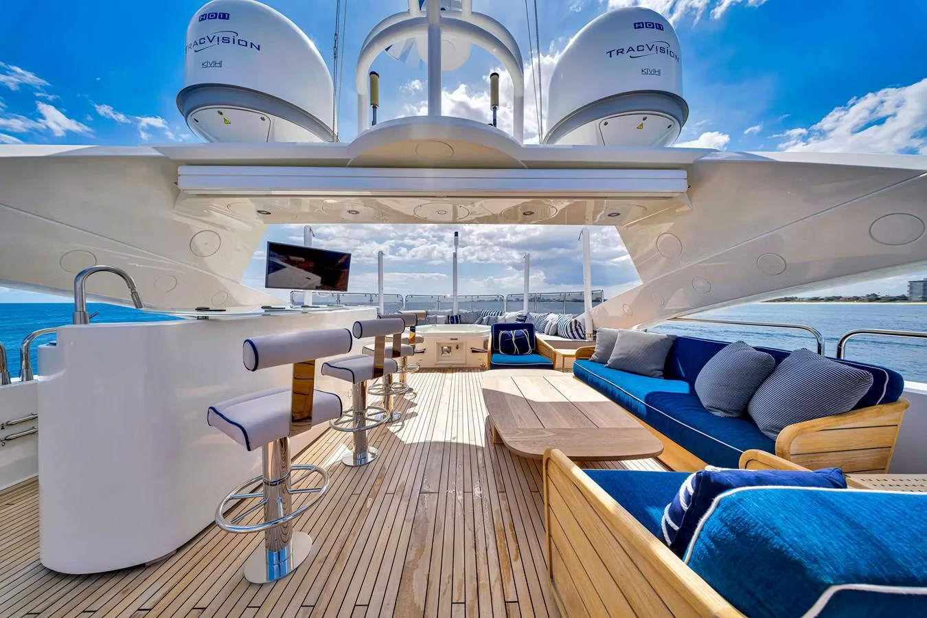 a boat with a deck and a deck and a large white building aboard NATURAL 9 Yacht for Charter