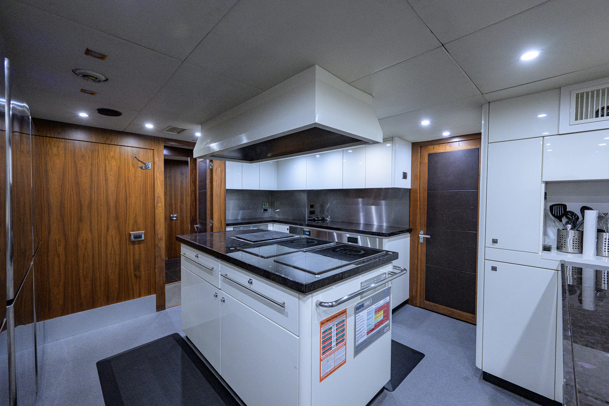 a kitchen with white cabinets aboard NATURAL 9 Yacht for Sale