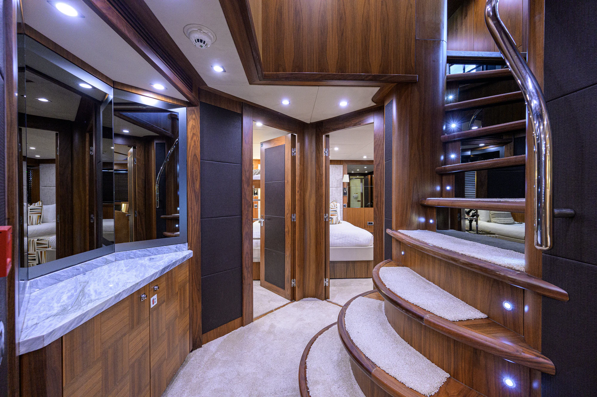 a room with a bed and a mirror aboard NATURAL 9 Yacht for Sale