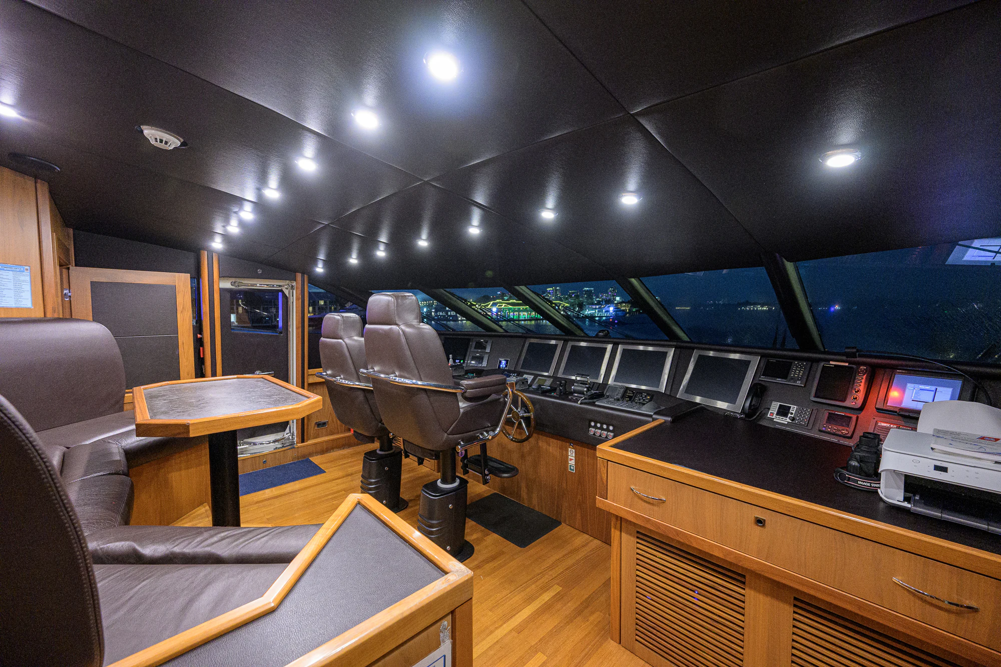a room with a desk and chairs aboard NATURAL 9 Yacht for Sale