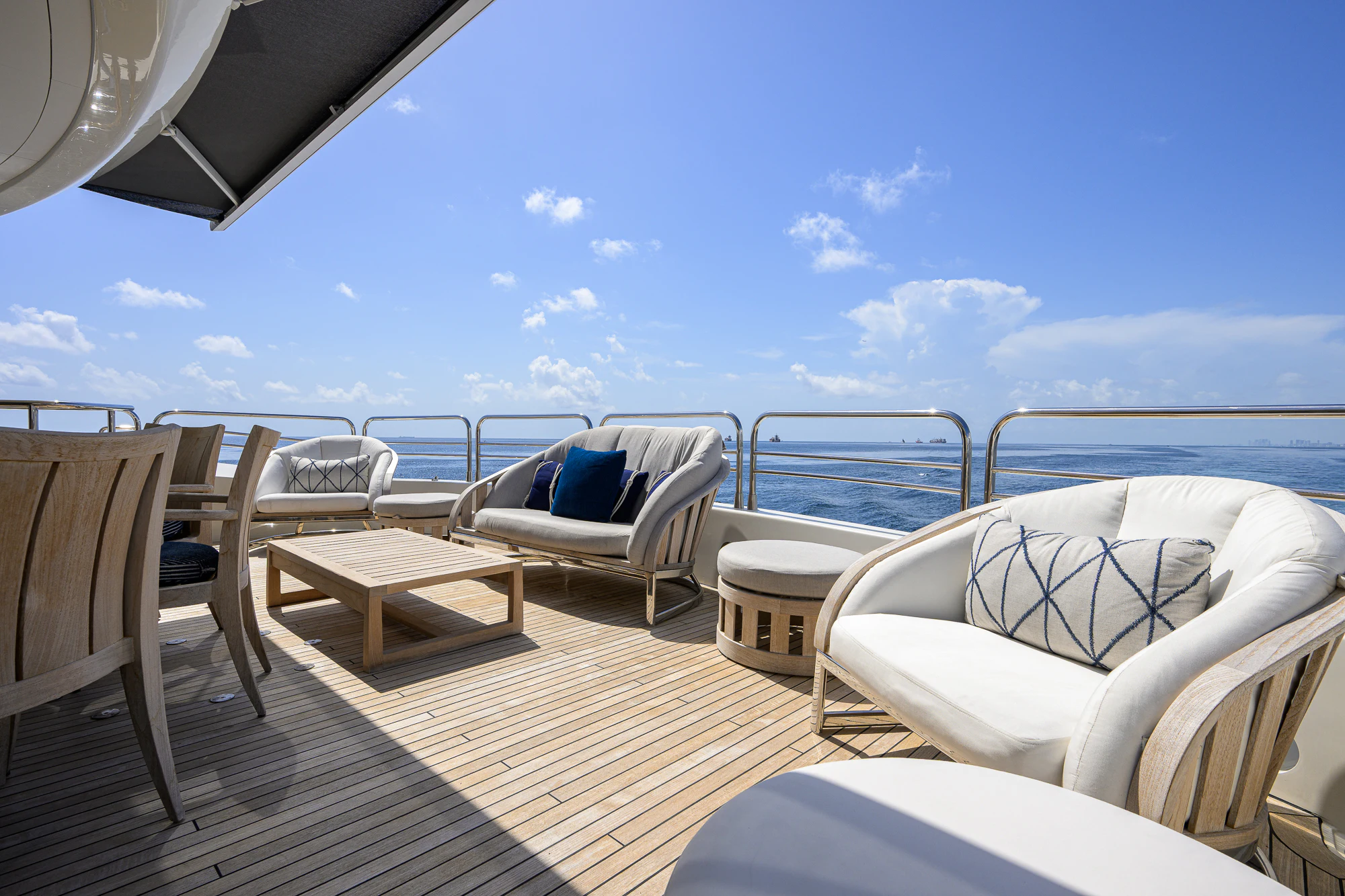 a deck with chairs and tables on it aboard NATURAL 9 Yacht for Sale
