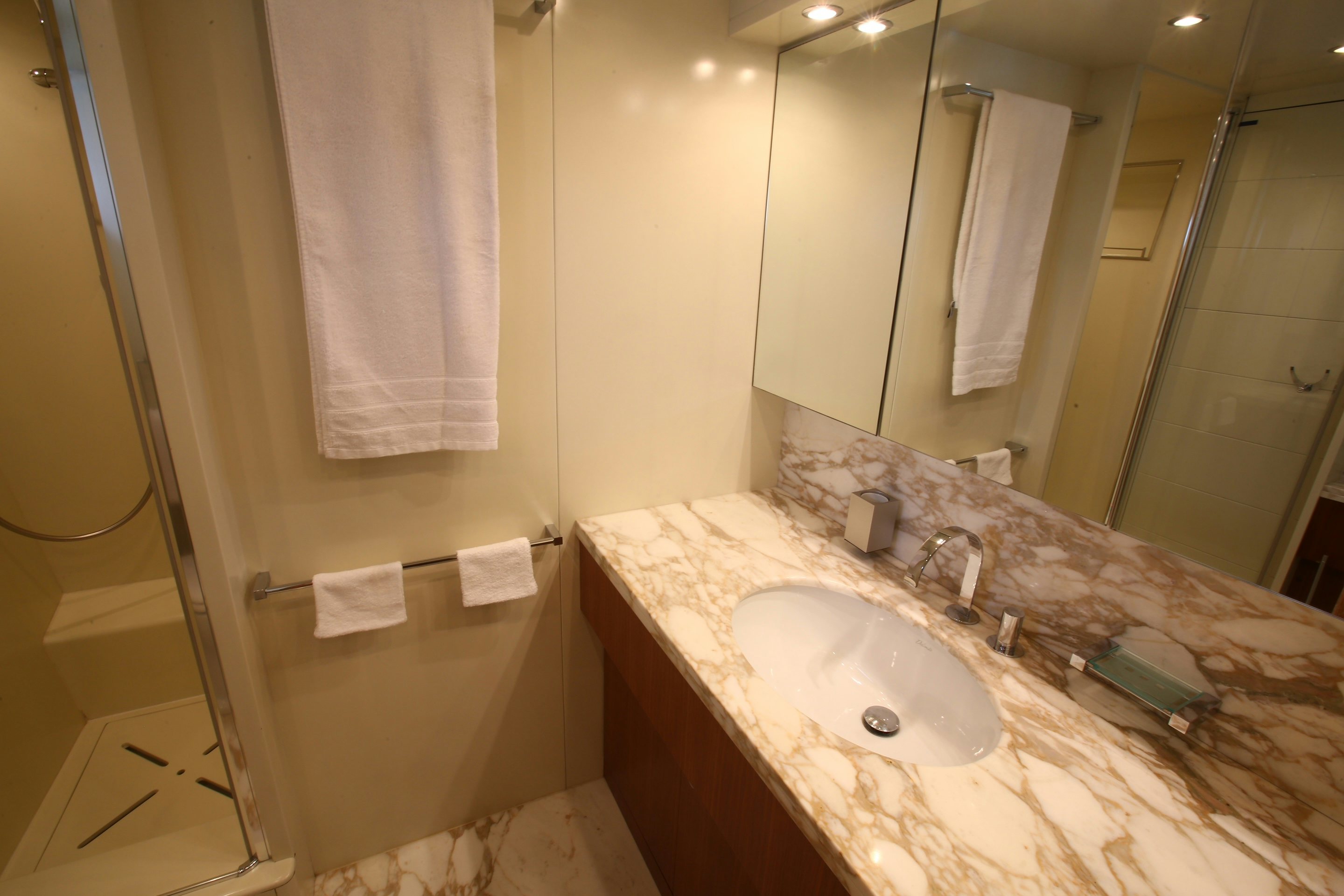 a bathroom with a sink and a mirror aboard YAKOS Yacht for Sale