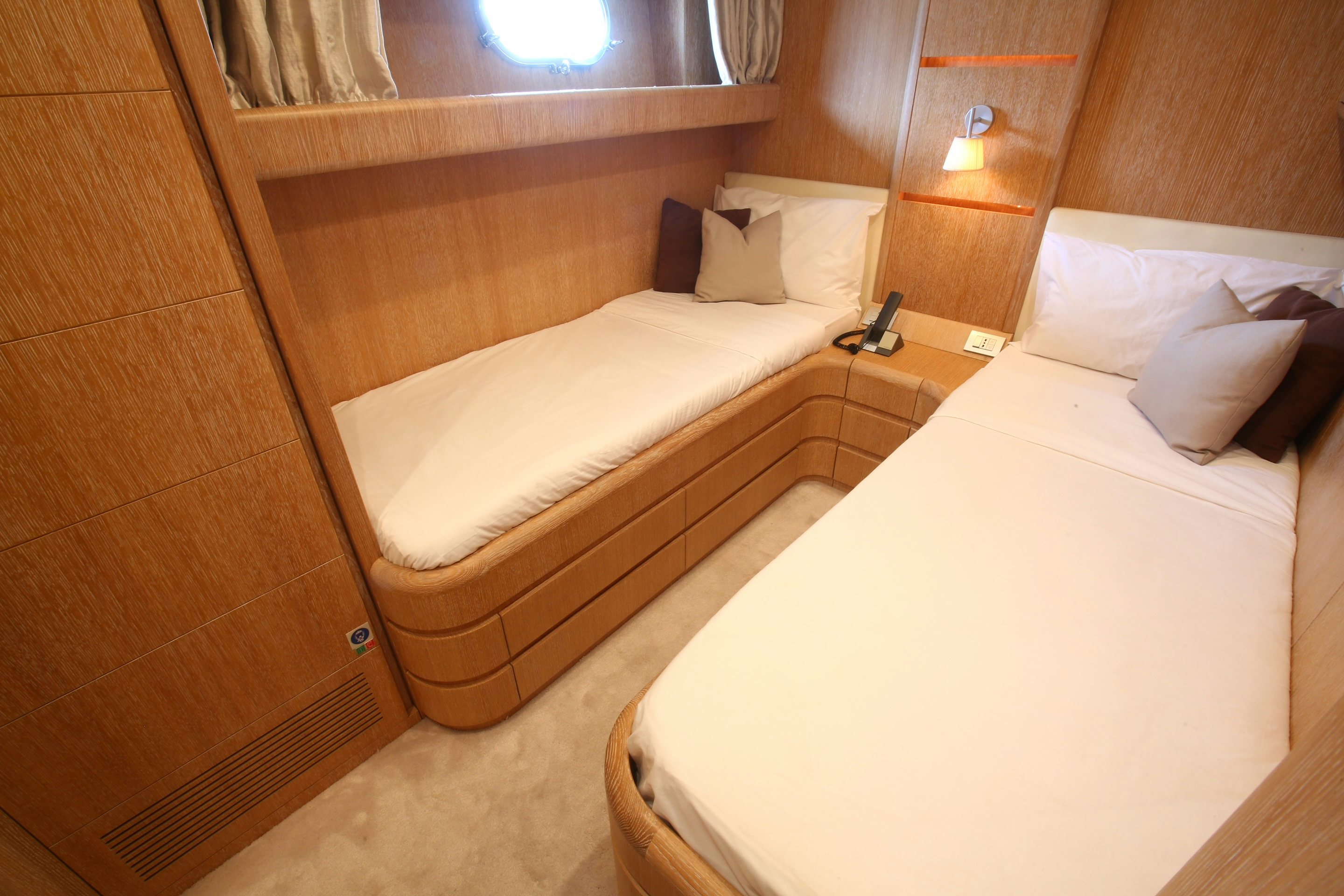 a room with a bed and a mirror aboard YAKOS Yacht for Sale