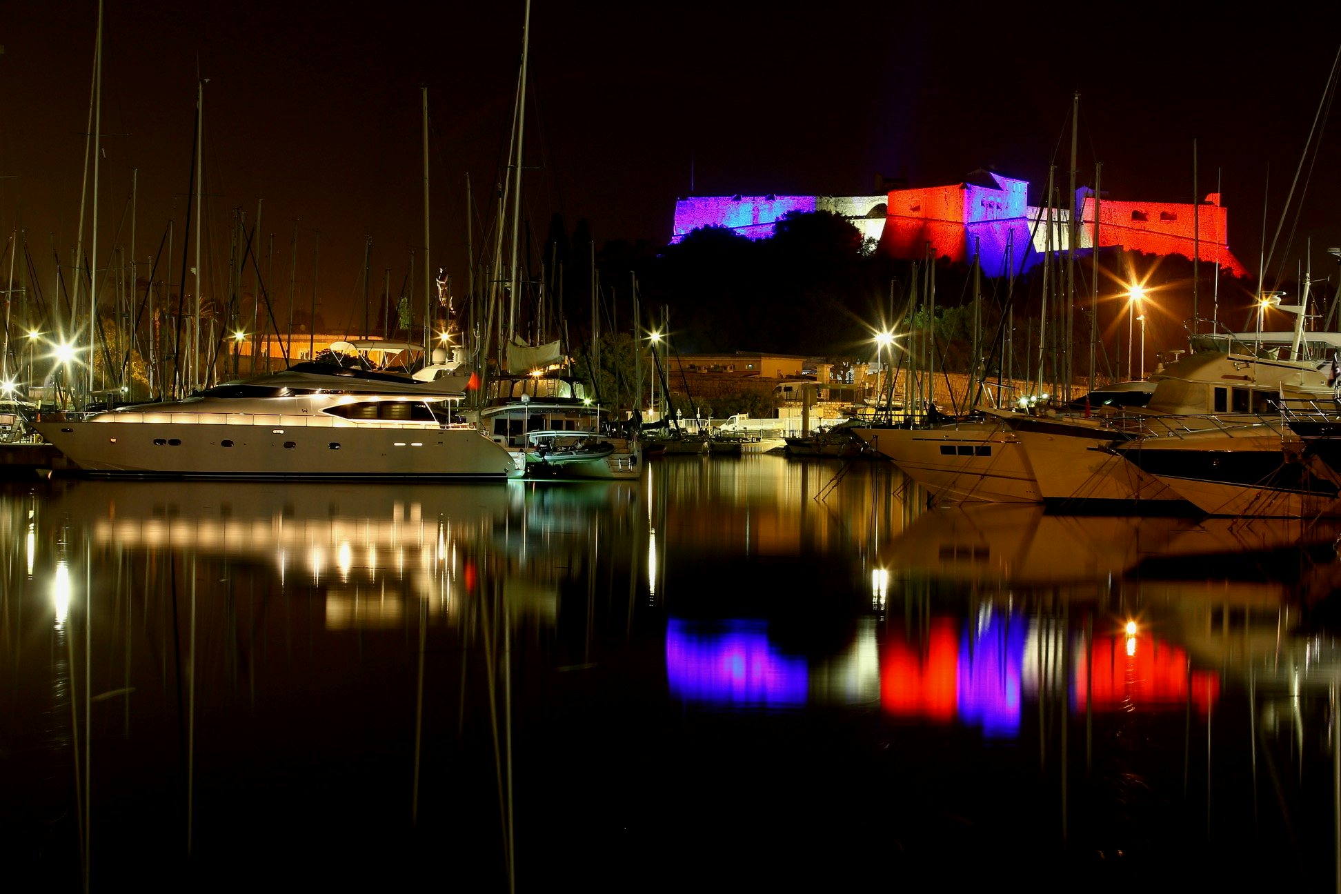 boats in a harbor at night aboard YAKOS Yacht for Sale