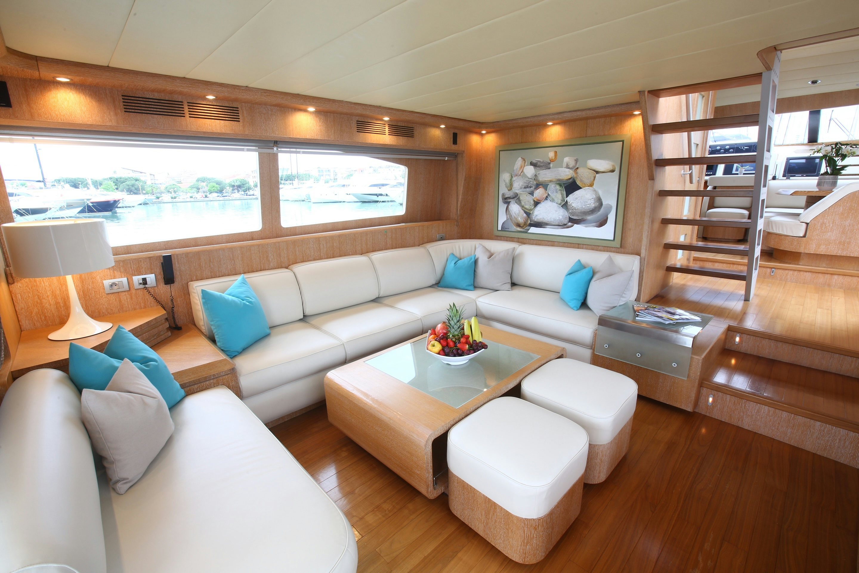 a living room with a couch and a table aboard YAKOS Yacht for Sale
