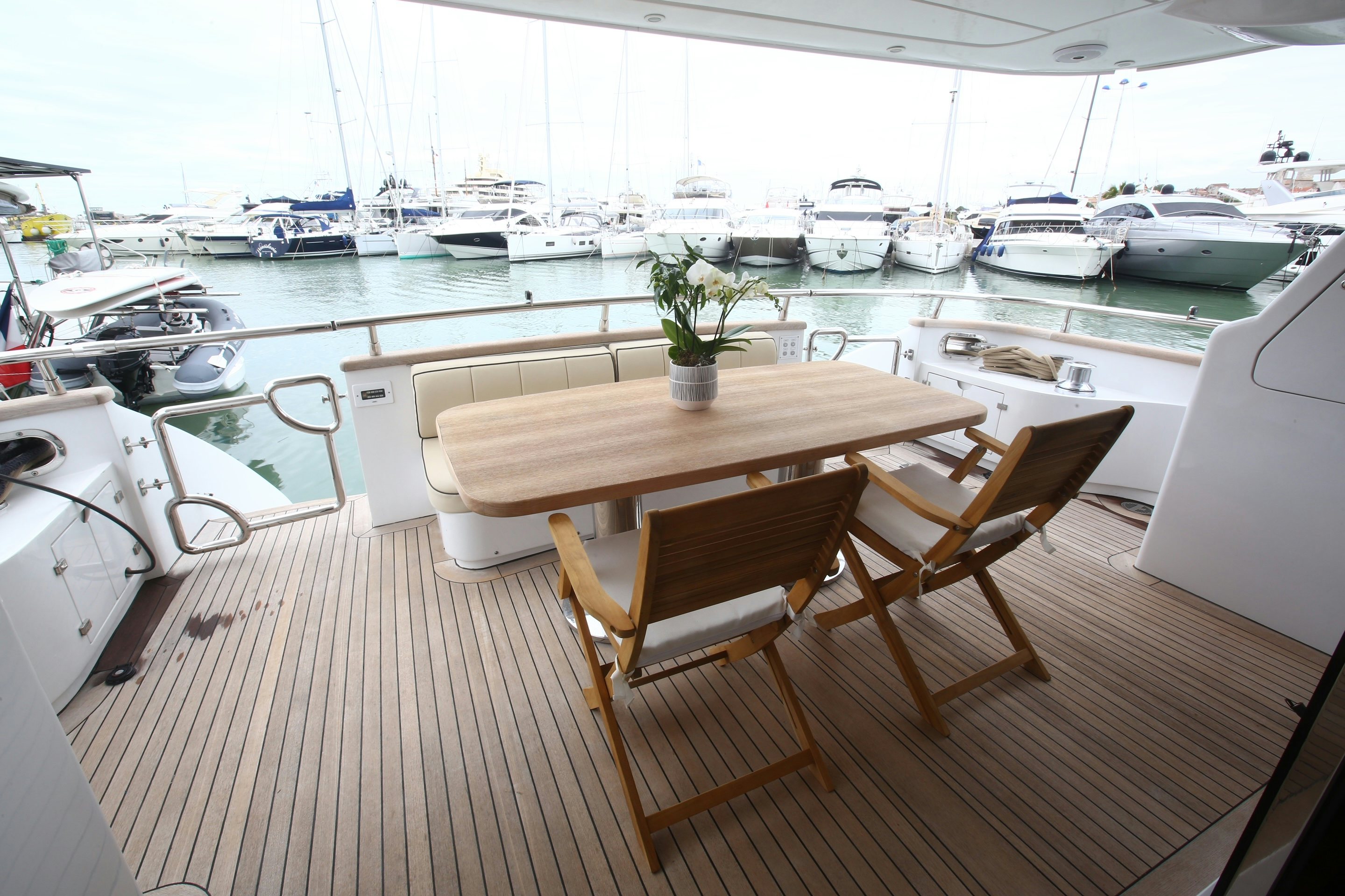 a table and chairs on a deck aboard YAKOS Yacht for Sale