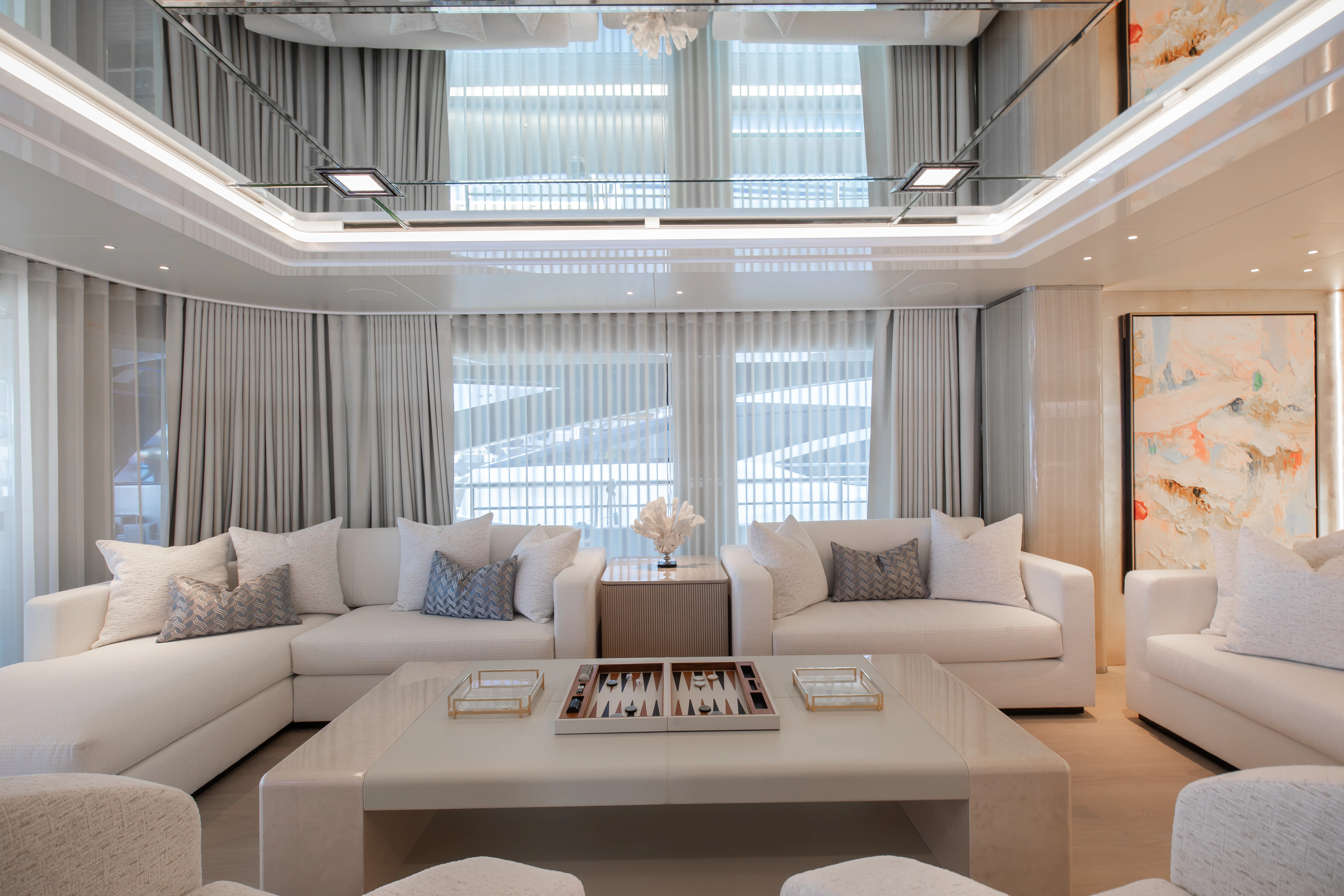 a living room with a large window aboard PERSEVERANCE Yacht for Charter