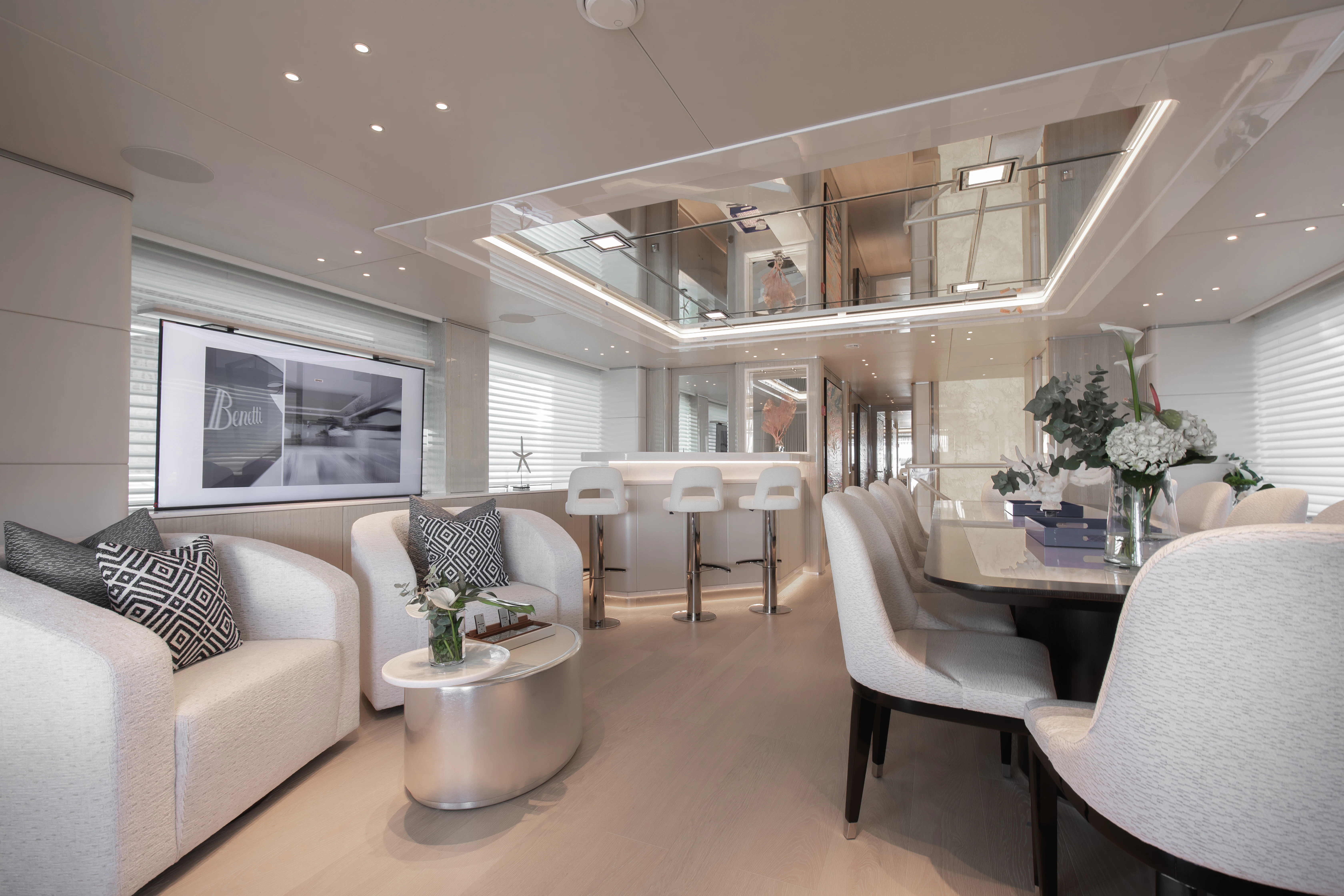 a living room with white furniture aboard PERSEVERANCE Yacht for Charter