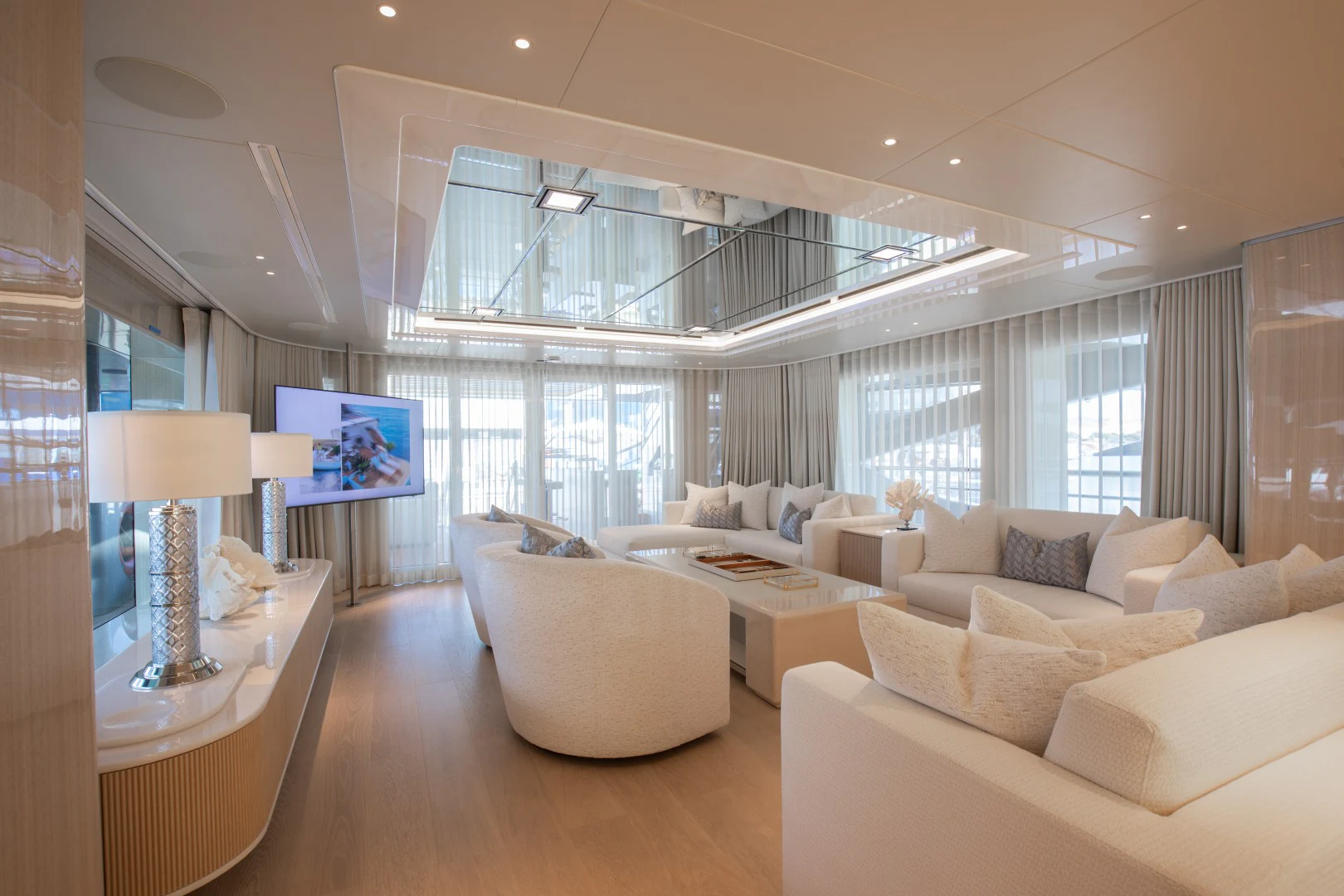 a living room with a large window aboard PERSEVERANCE Yacht for Charter
