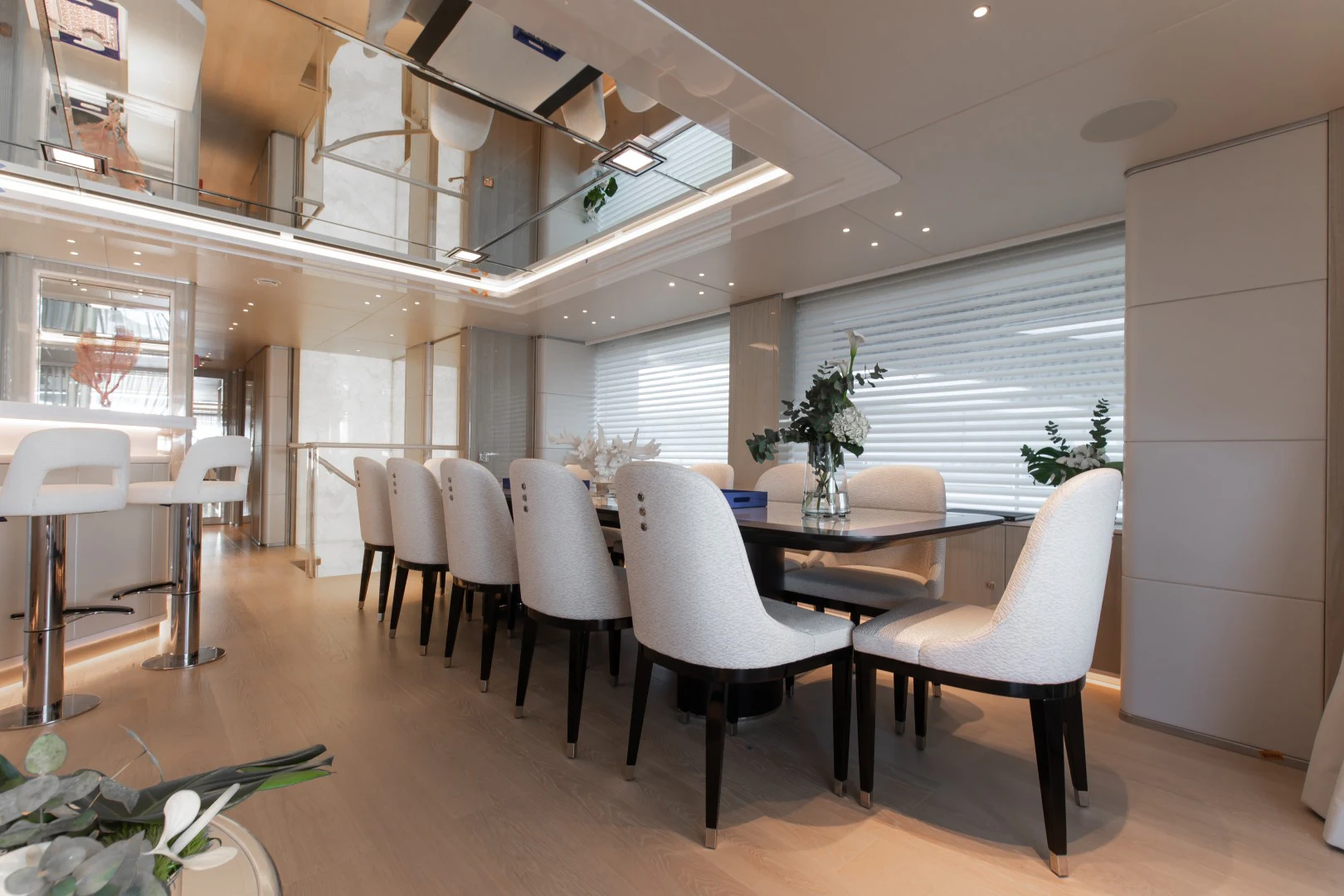 a room with tables and chairs aboard PERSEVERANCE Yacht for Charter