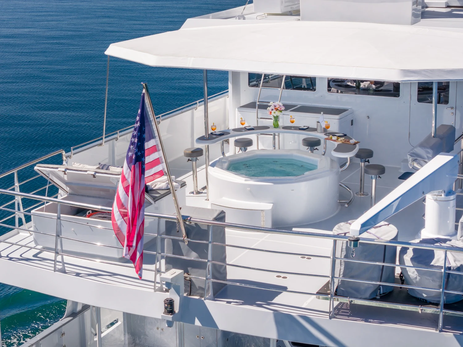 a boat with a flag on the front aboard SURFBIRD Yacht for Charter