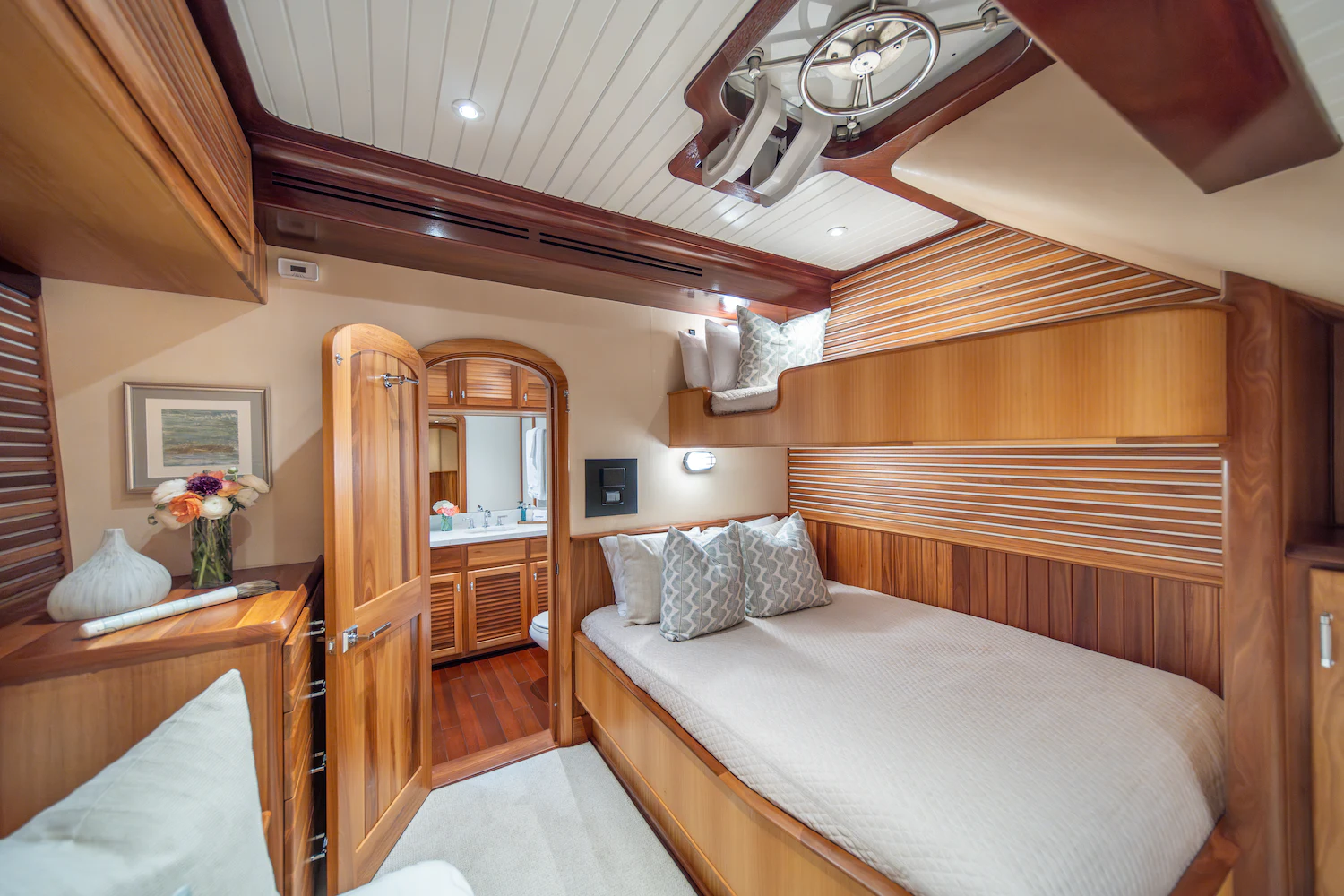 a bedroom with a bed and a wood door aboard SURFBIRD Yacht for Charter