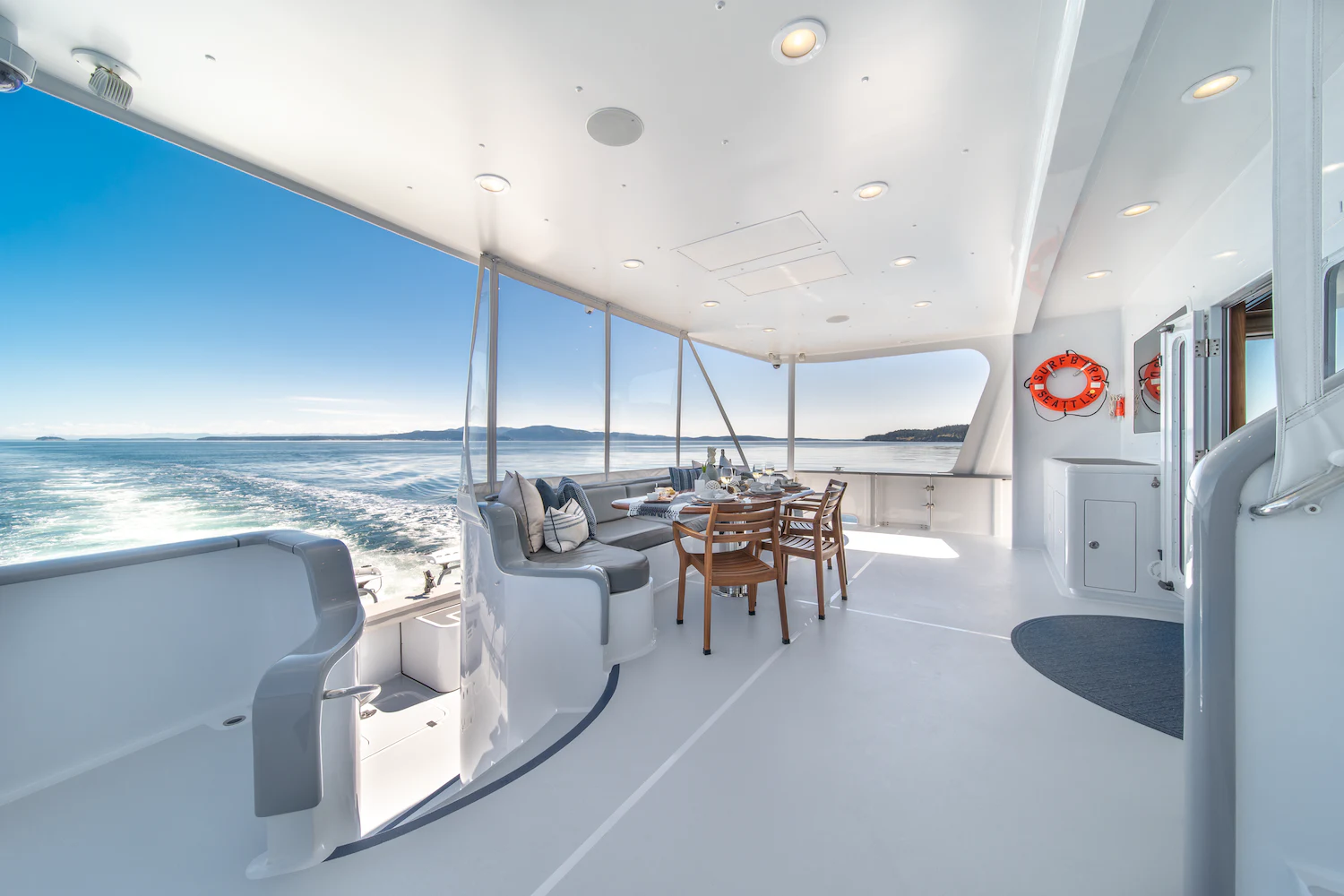 a room with a view of the ocean and the deck aboard SURFBIRD Yacht for Charter