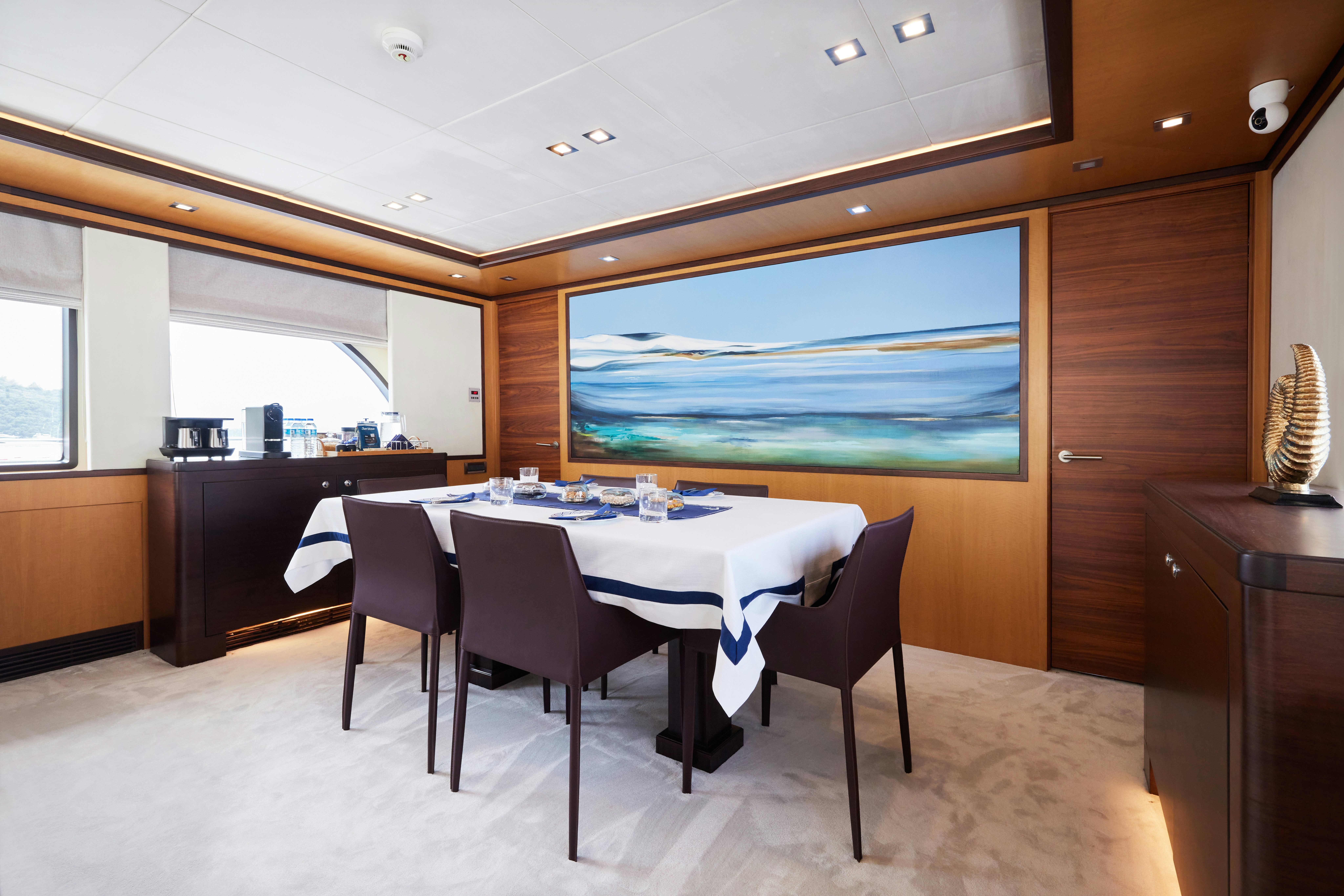 a large kitchen with a table and chairs aboard AYSHA Yacht for Sale