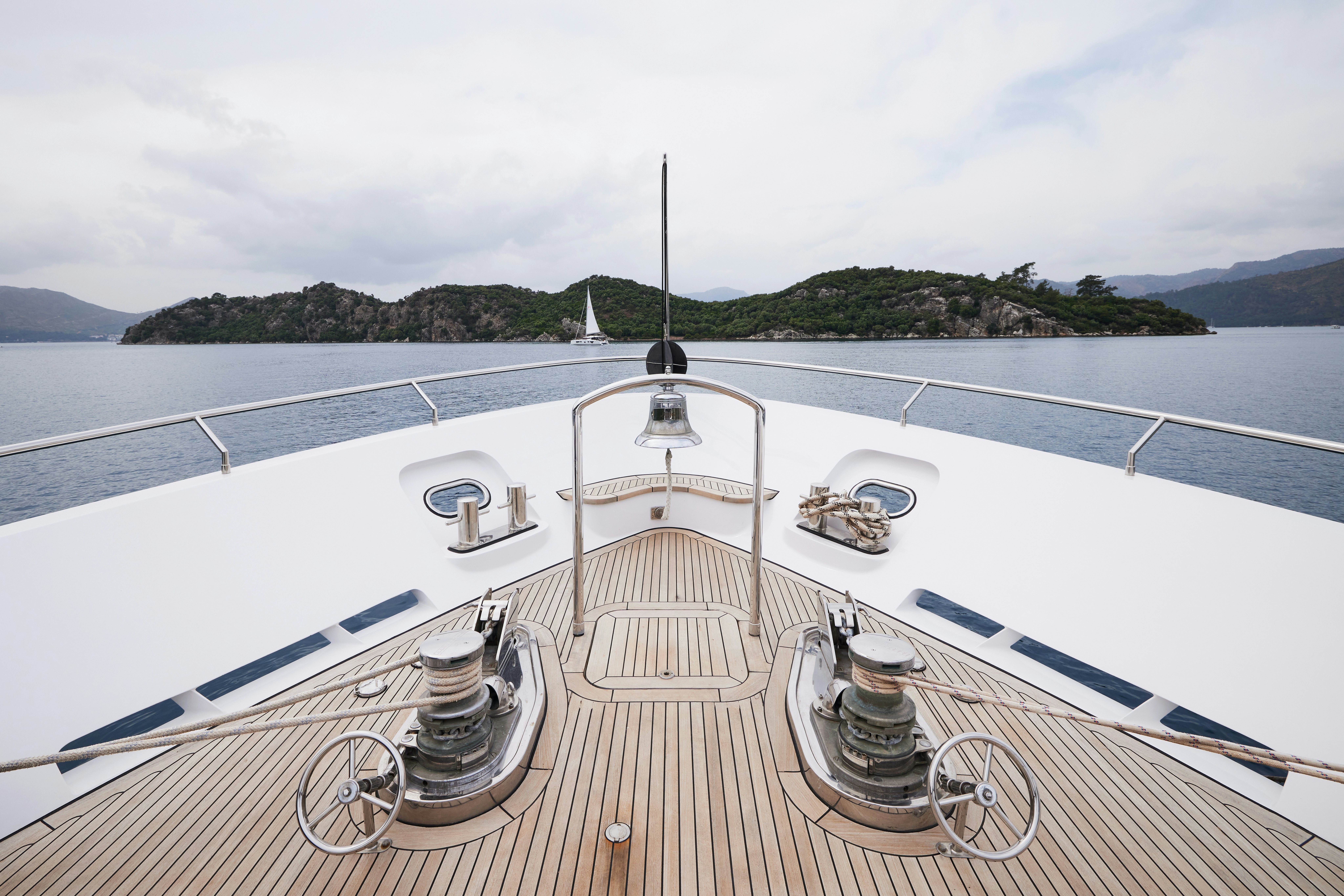 a deck with a view of the ocean and land aboard AYSHA Yacht for Sale