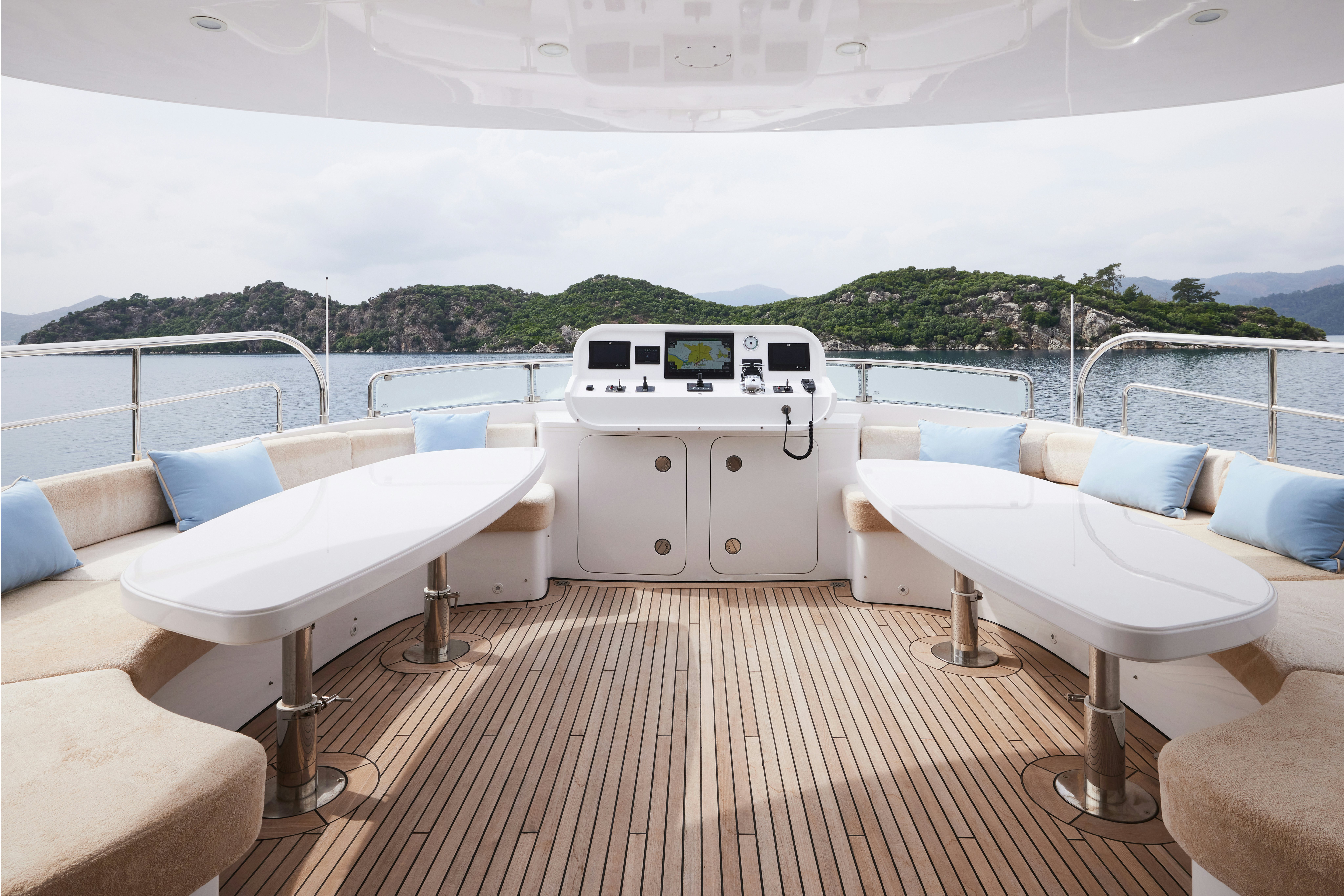 a white table and chairs on a deck with a large white table and a white table and a aboard AYSHA Yacht for Sale