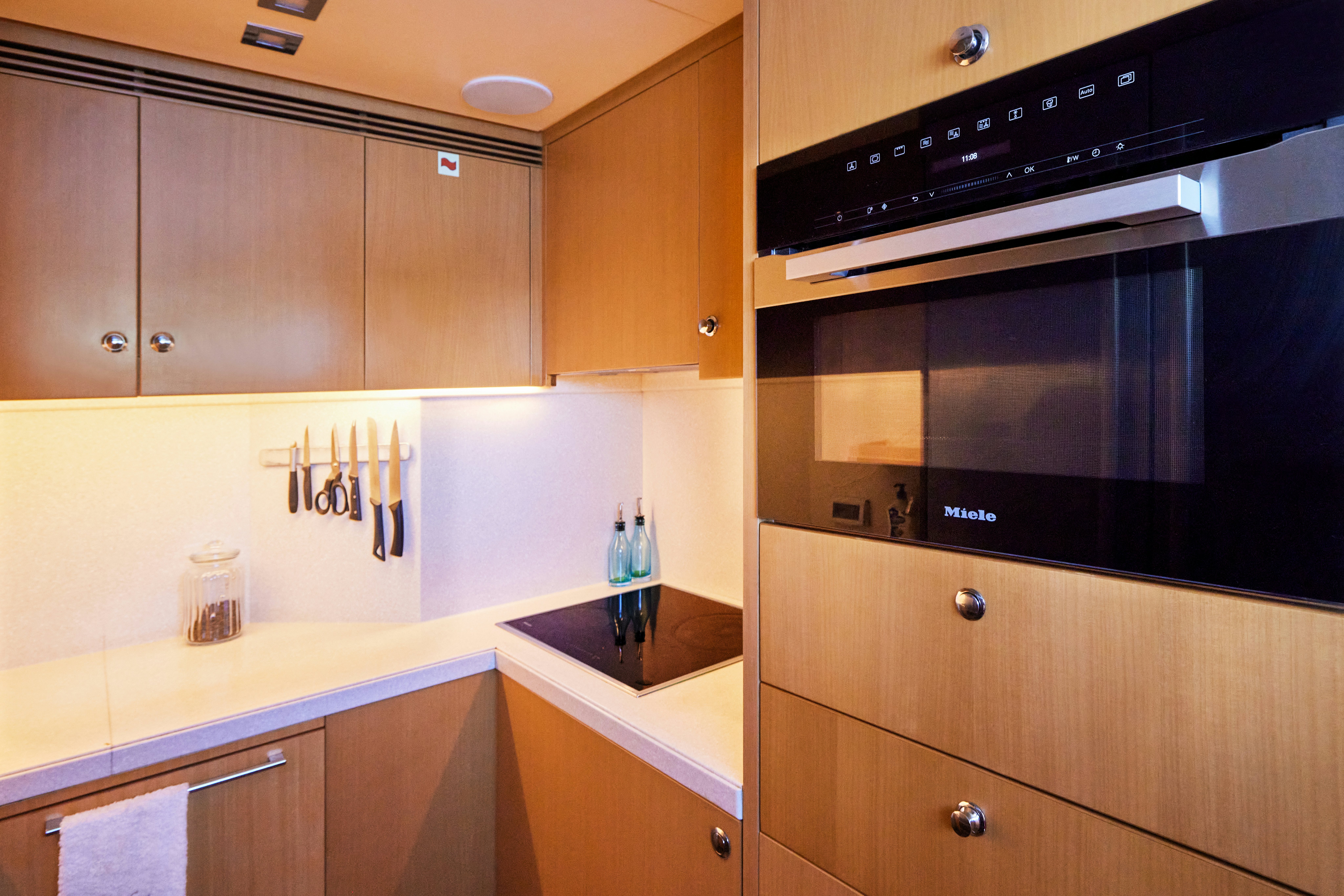 a kitchen with wooden cabinets aboard AYSHA Yacht for Sale