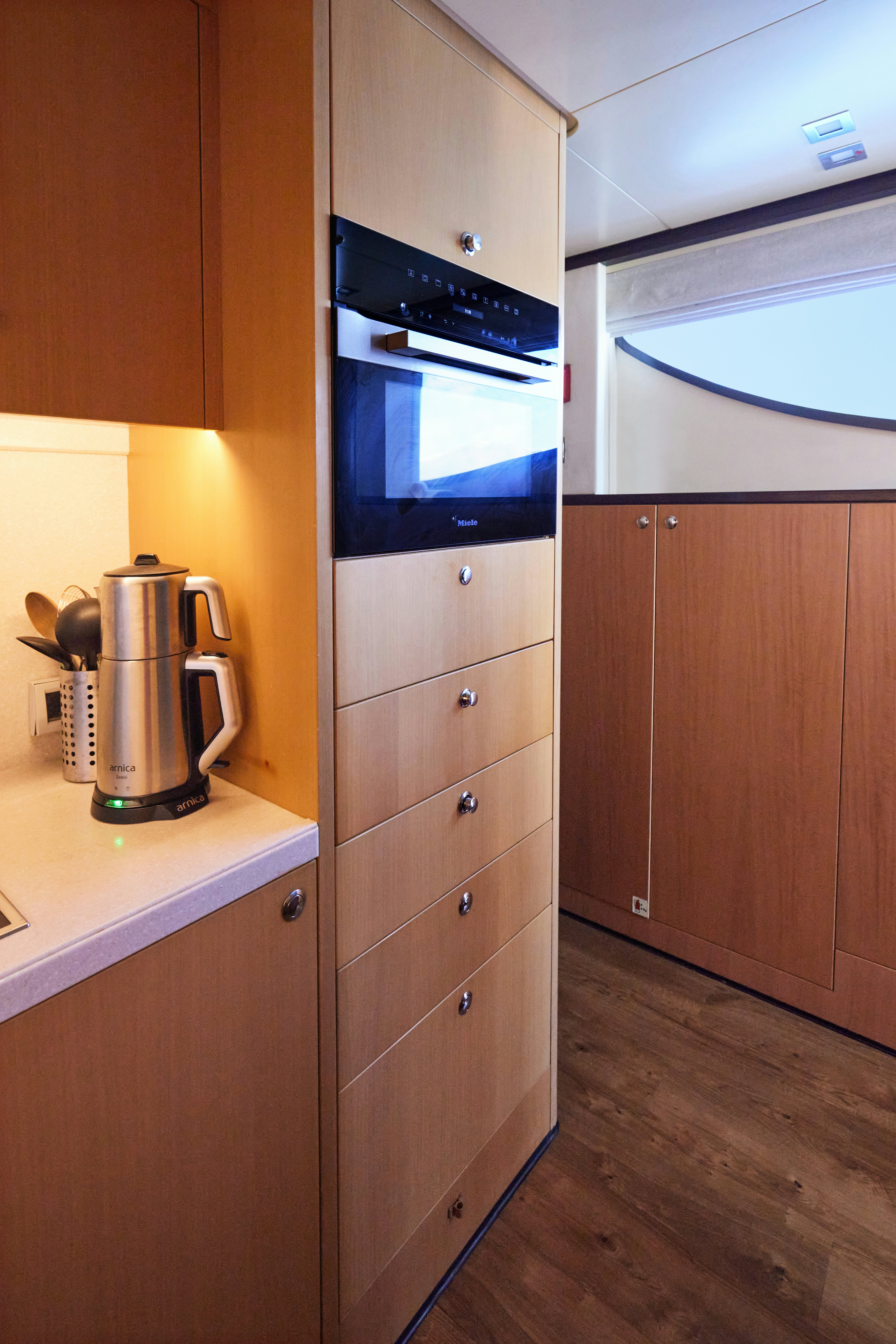 a kitchen with wooden cabinets aboard AYSHA Yacht for Sale