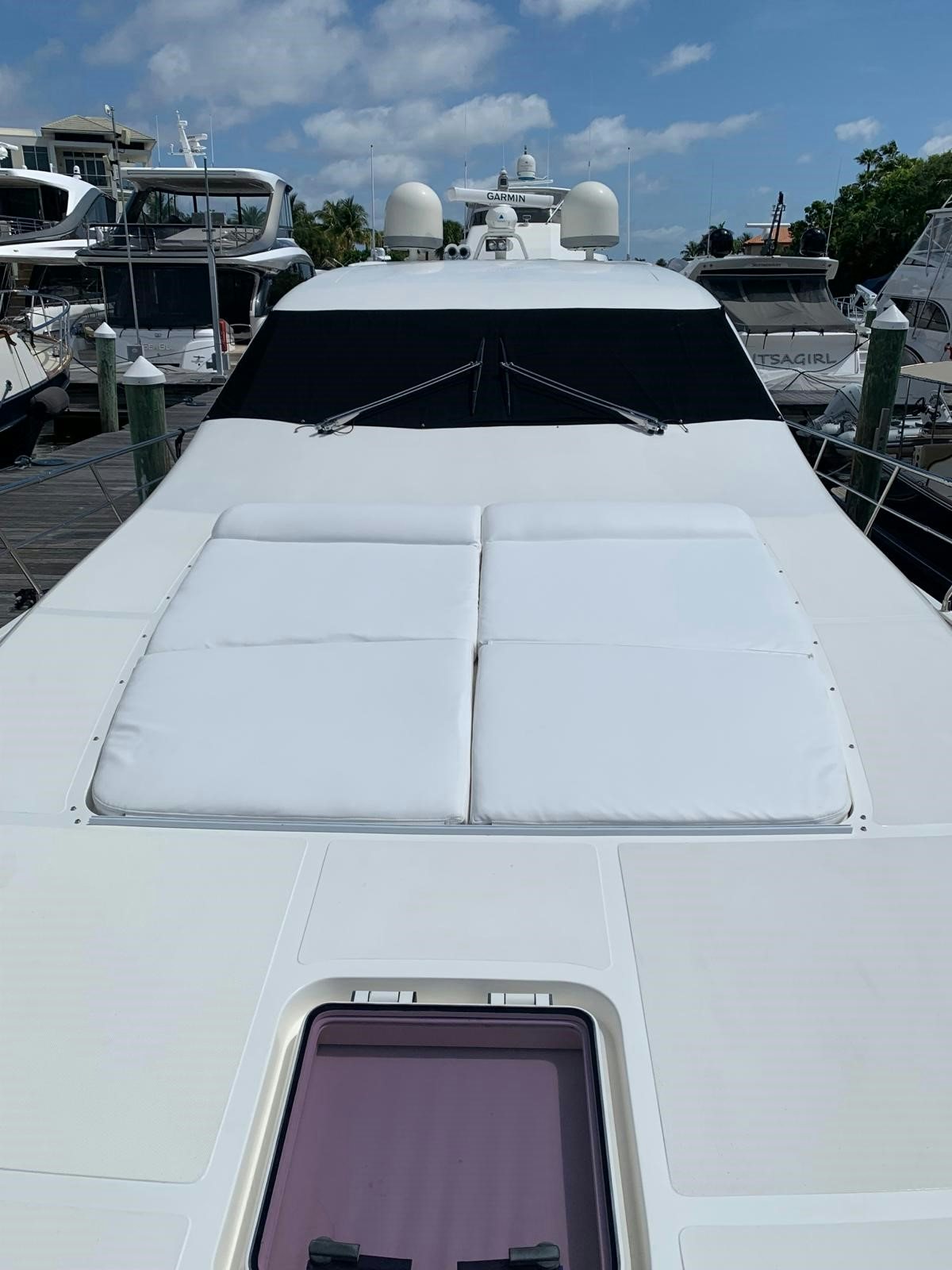 a white boat with a black and red stripe on it aboard EQUINOX Yacht for Sale
