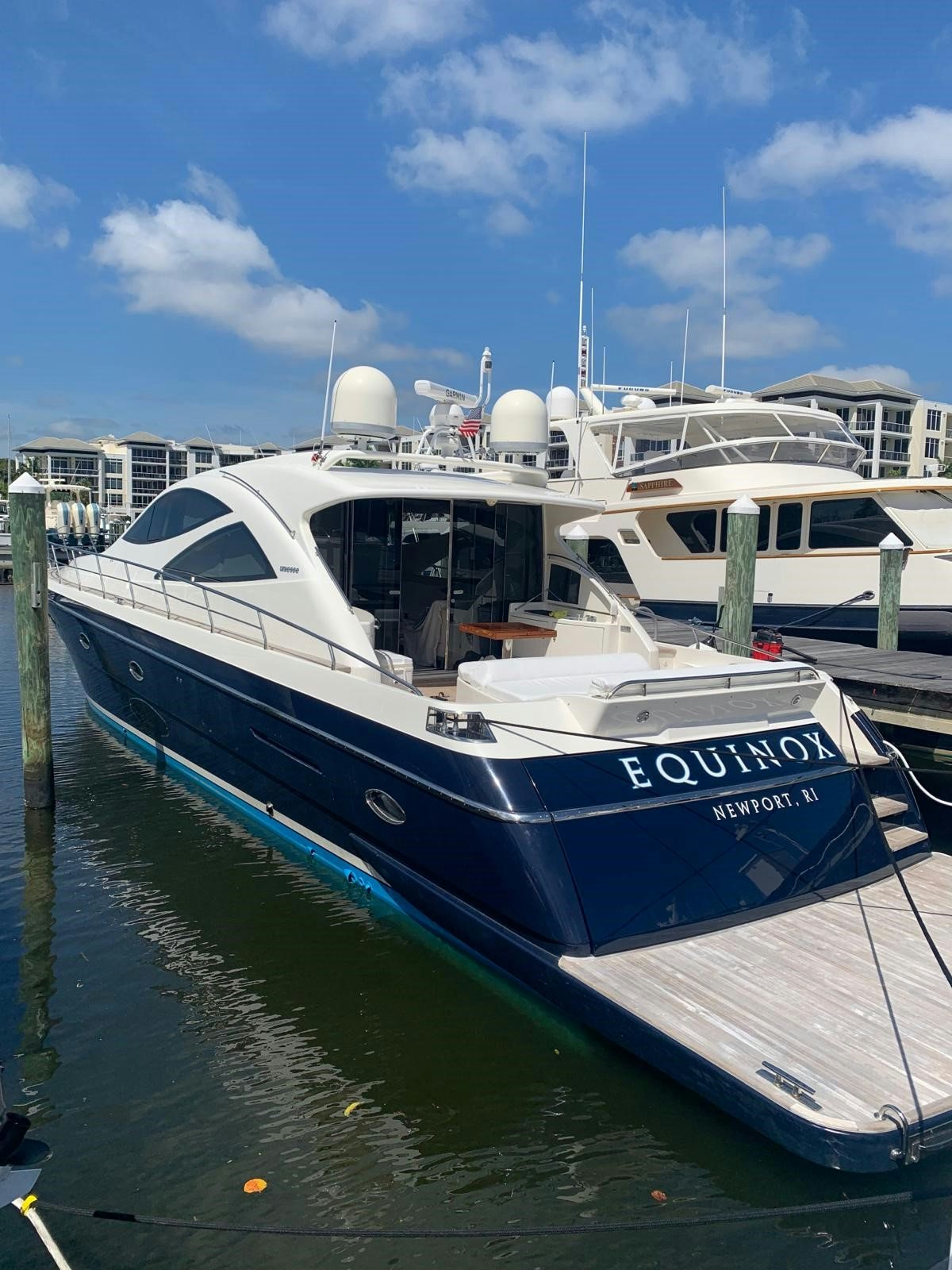 a boat docked at a pier aboard EQUINOX Yacht for Sale