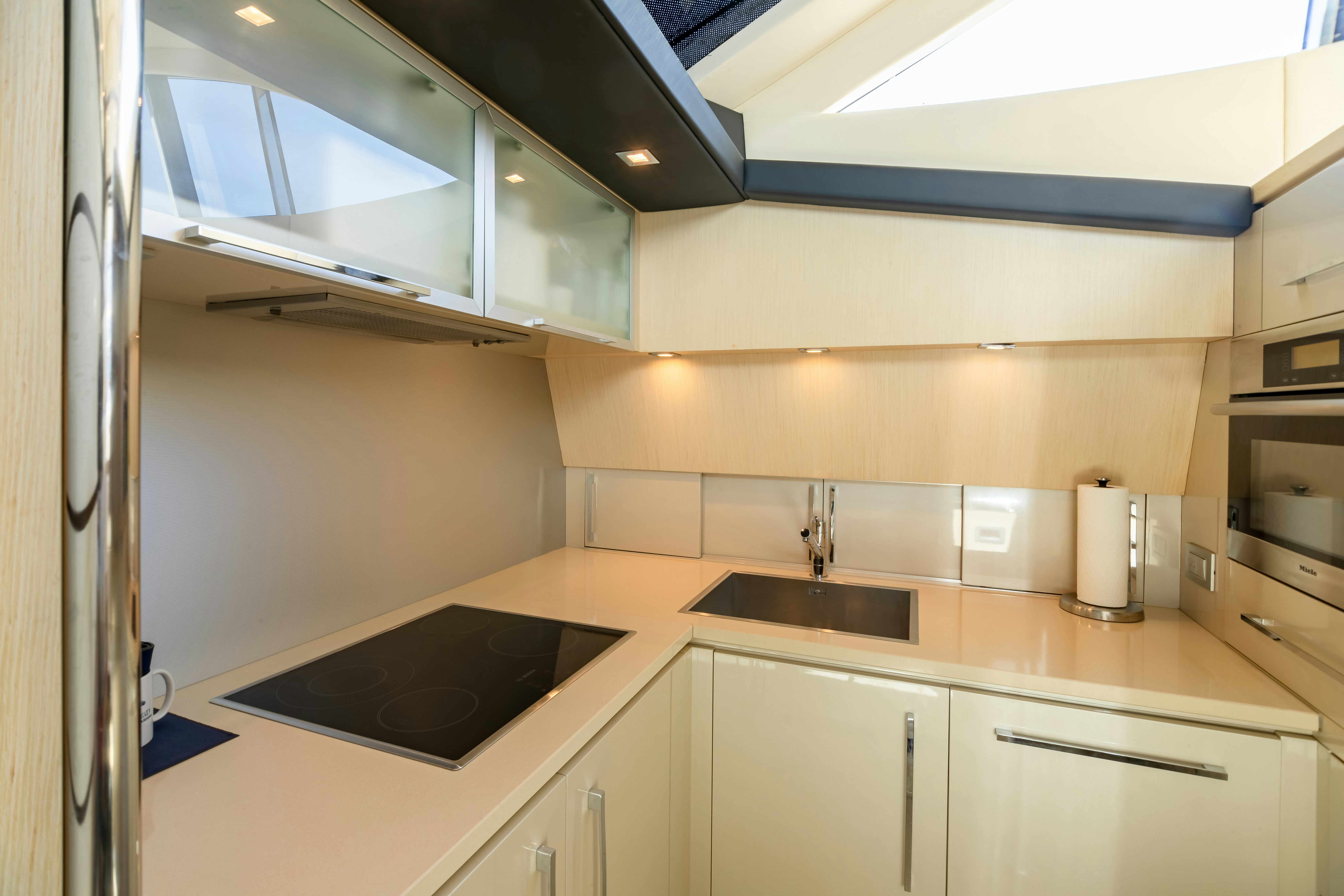 a kitchen with white cabinets aboard EQUINOX Yacht for Sale