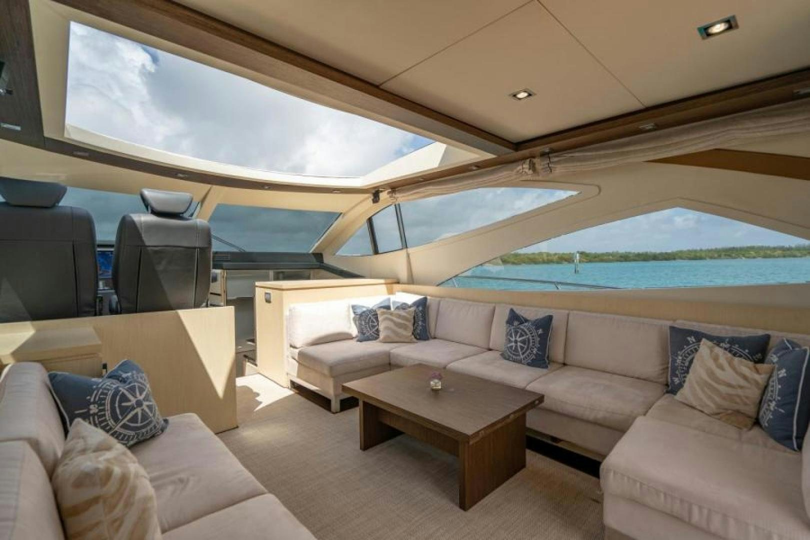 a room with a couch and a table and a pool aboard EQUINOX Yacht for Sale