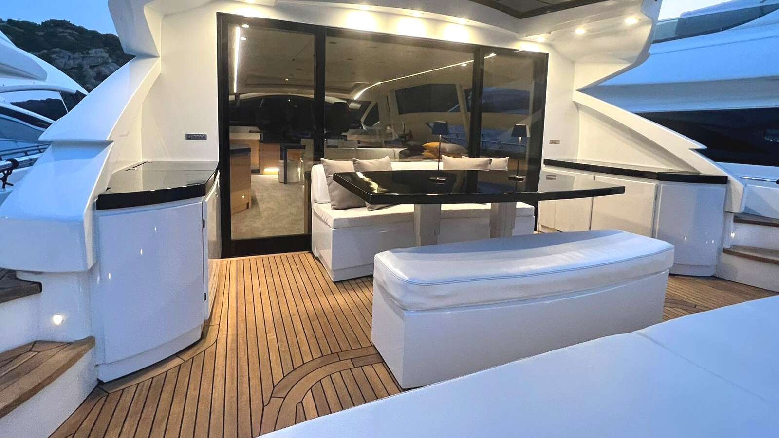 a room with a wood floor and a large white rectangular object with a wood floor and a wood aboard THYKE II Yacht for Charter