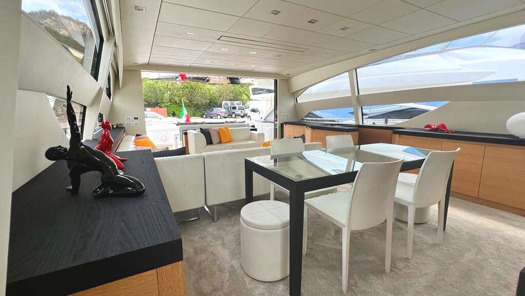 a room with tables and chairs aboard THYKE II Yacht for Charter