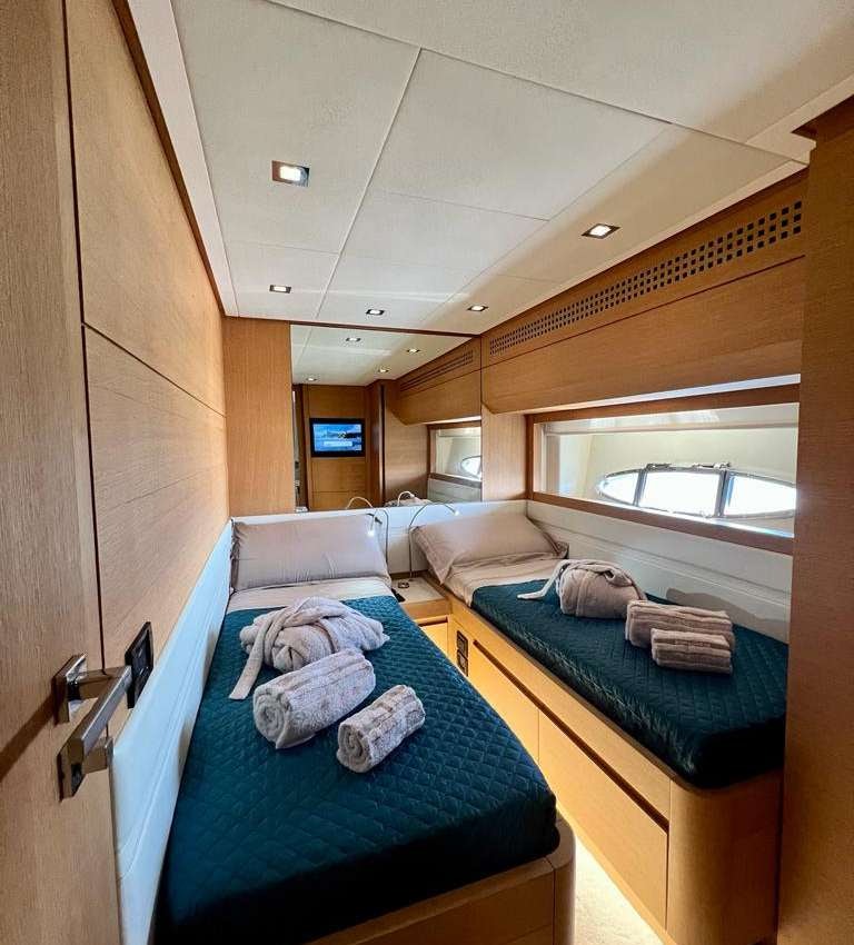 a small room with a bed and a window aboard THYKE II Yacht for Charter